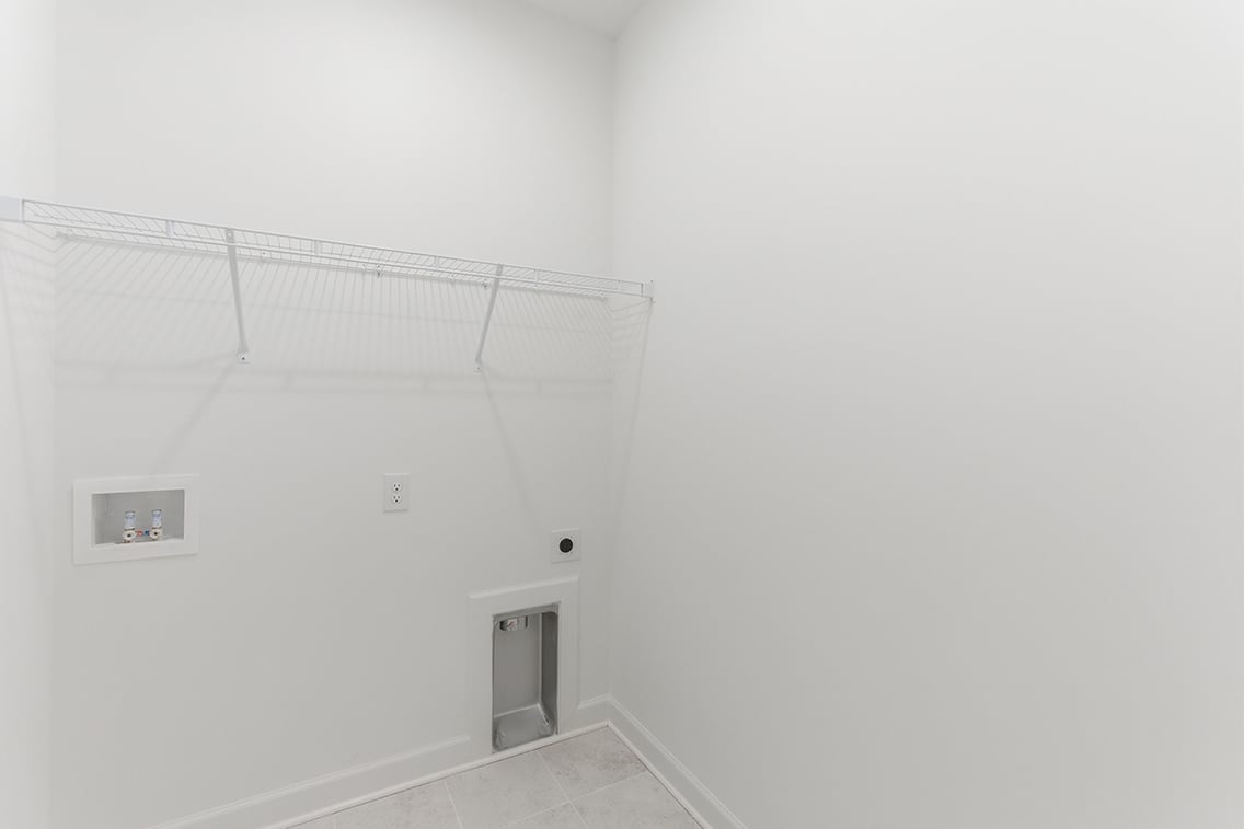 A white wall with a vent.