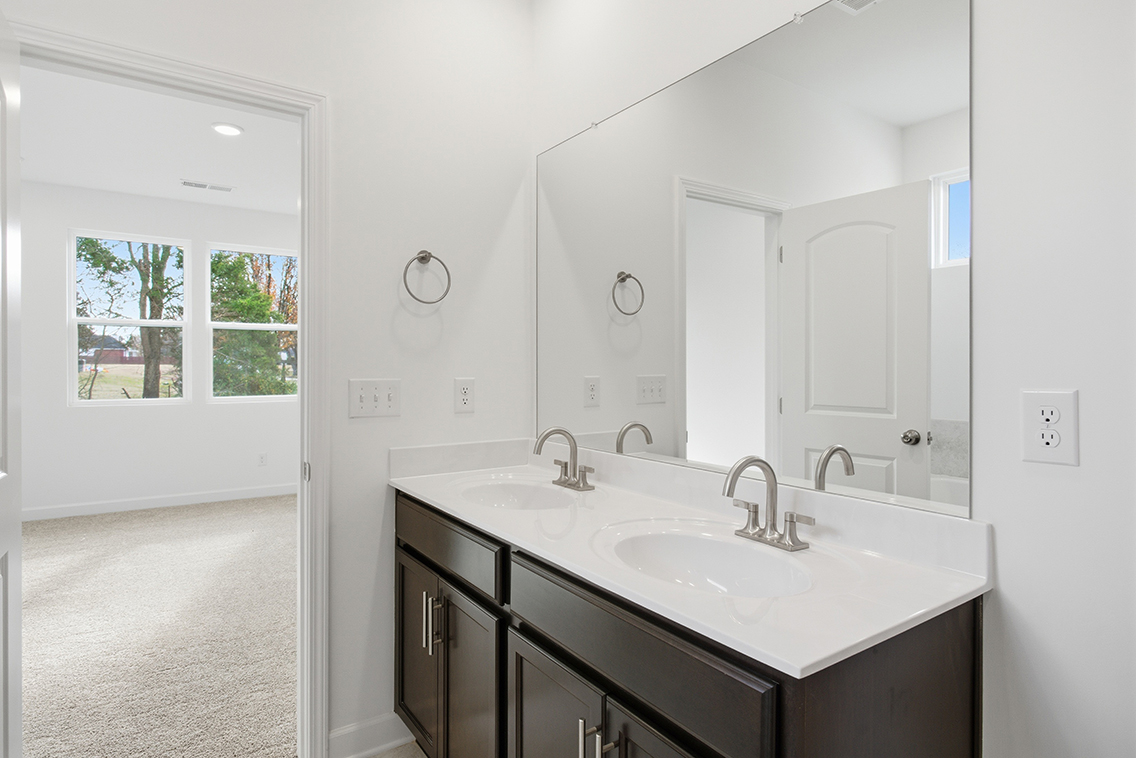 A bathroom with a large mirror.