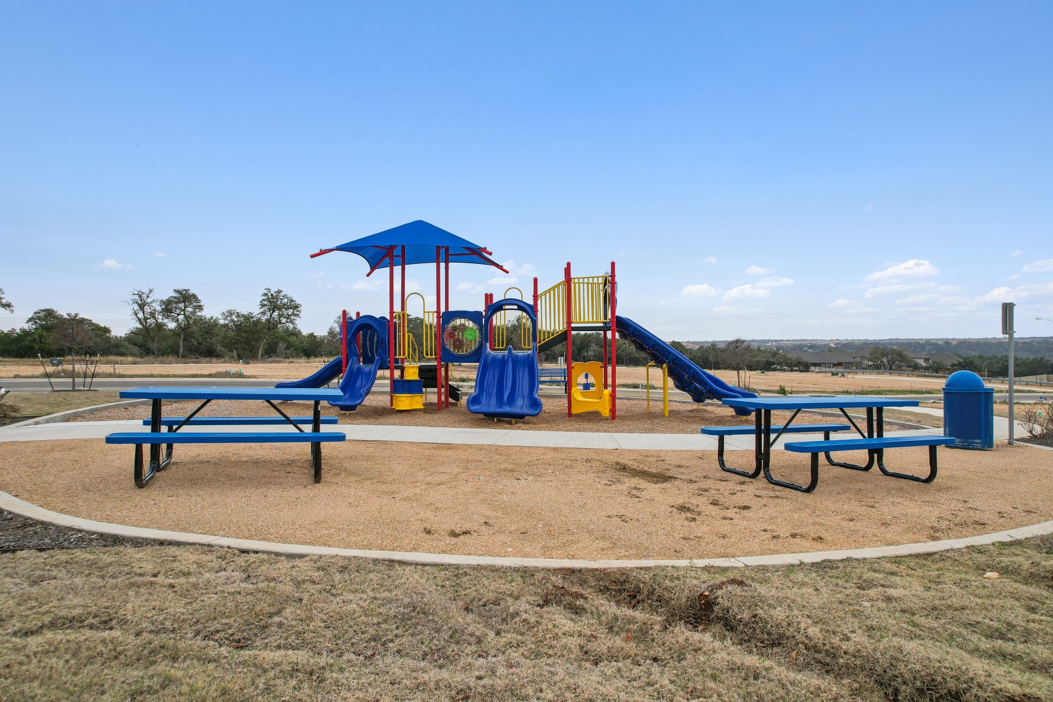 A playground with blue benches.