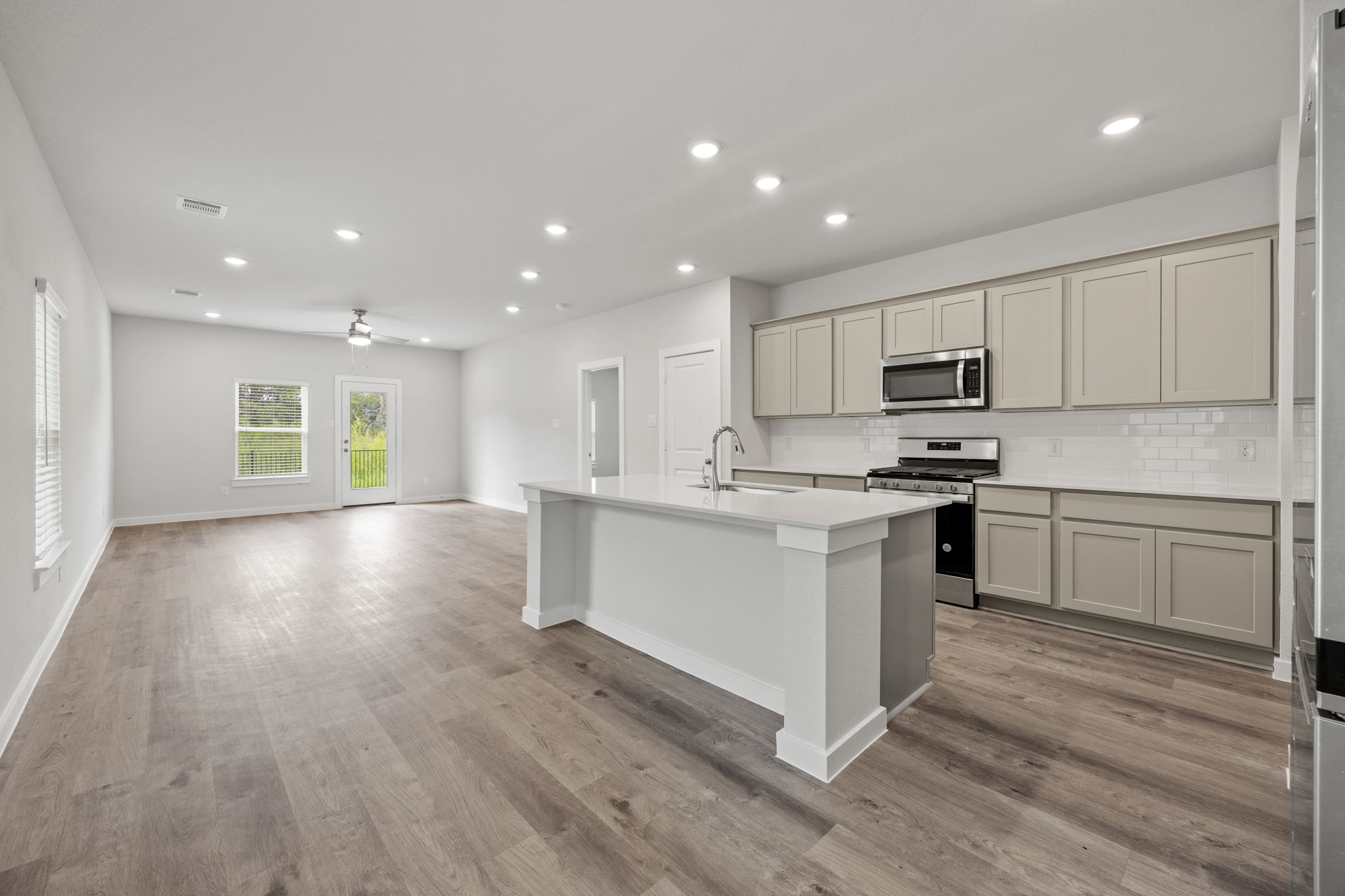 A kitchen with white cabinets.