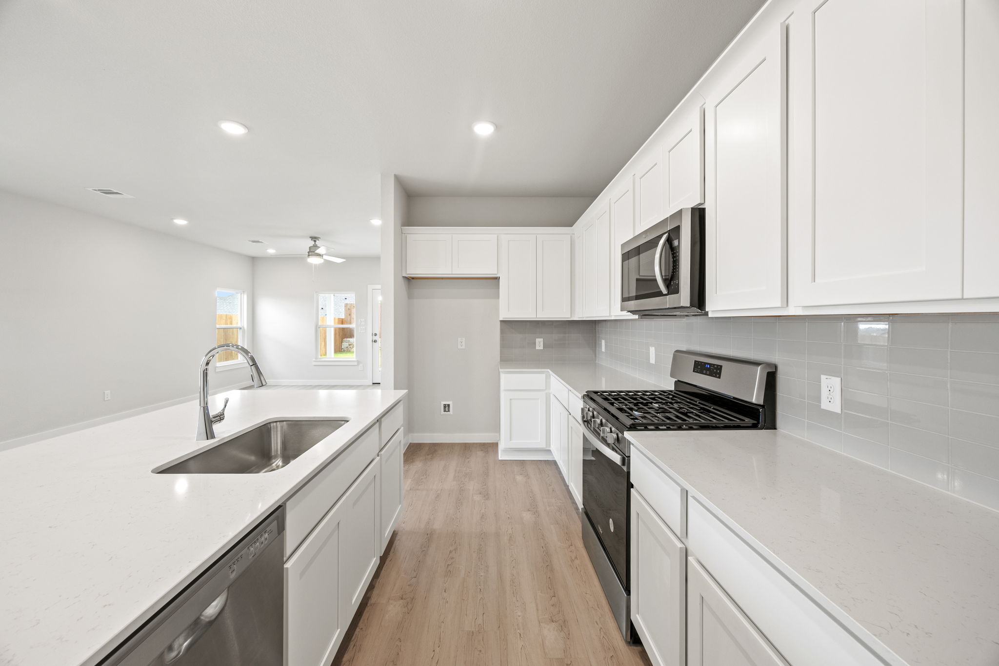 A kitchen with white cabinets.