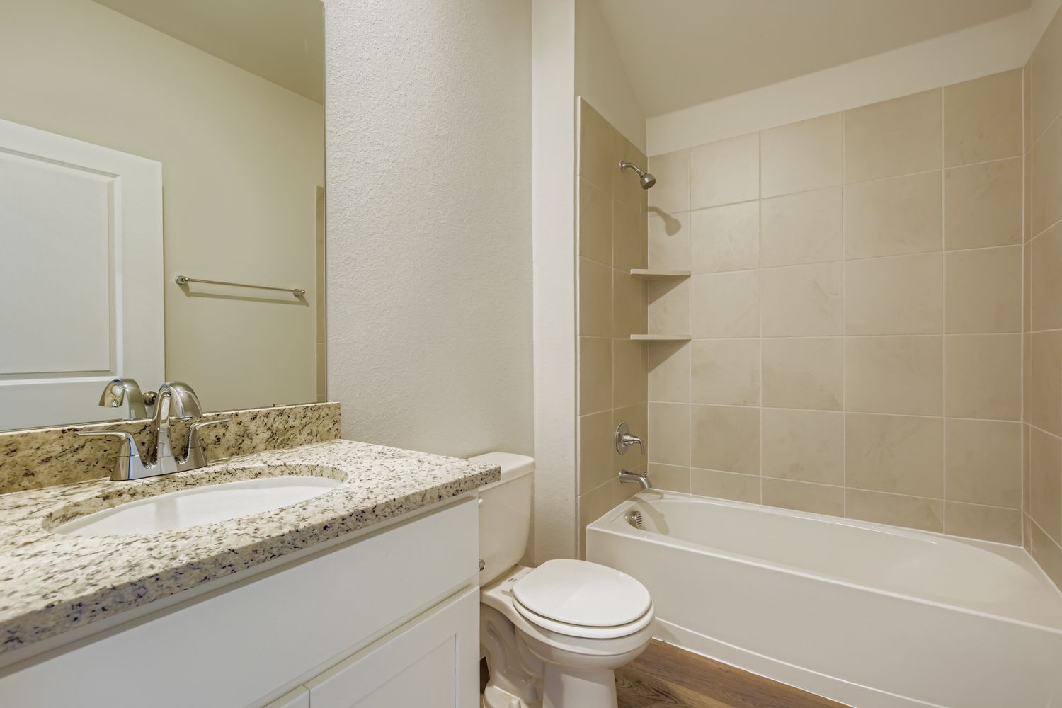 A bathroom with a tub sink and toilet.