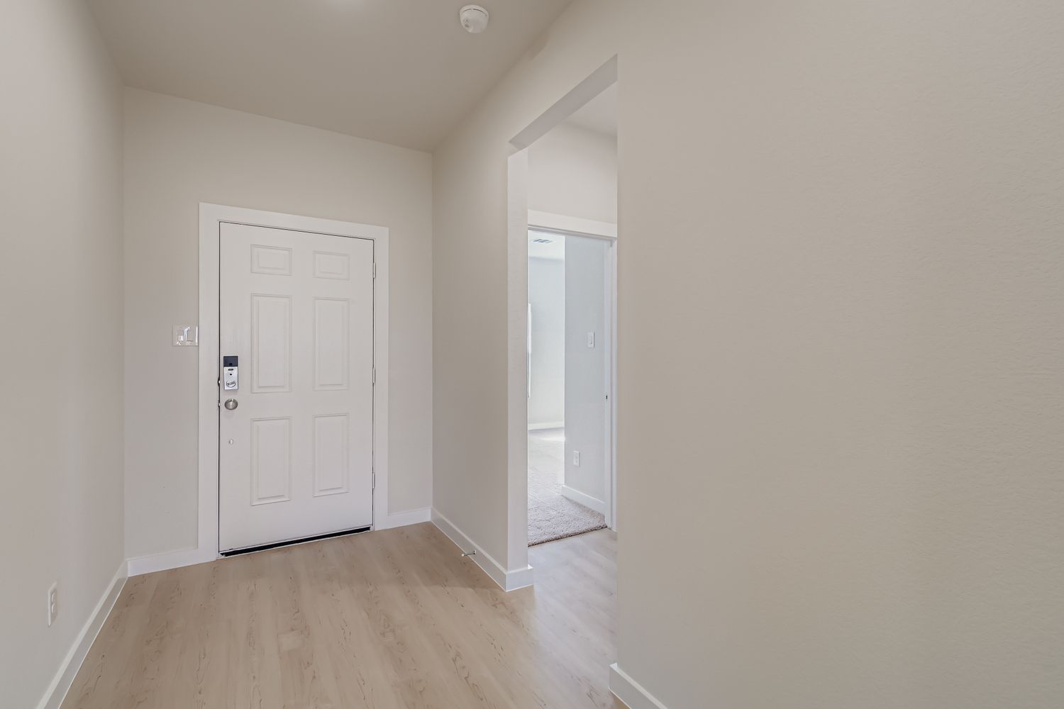 A hallway with white doors.