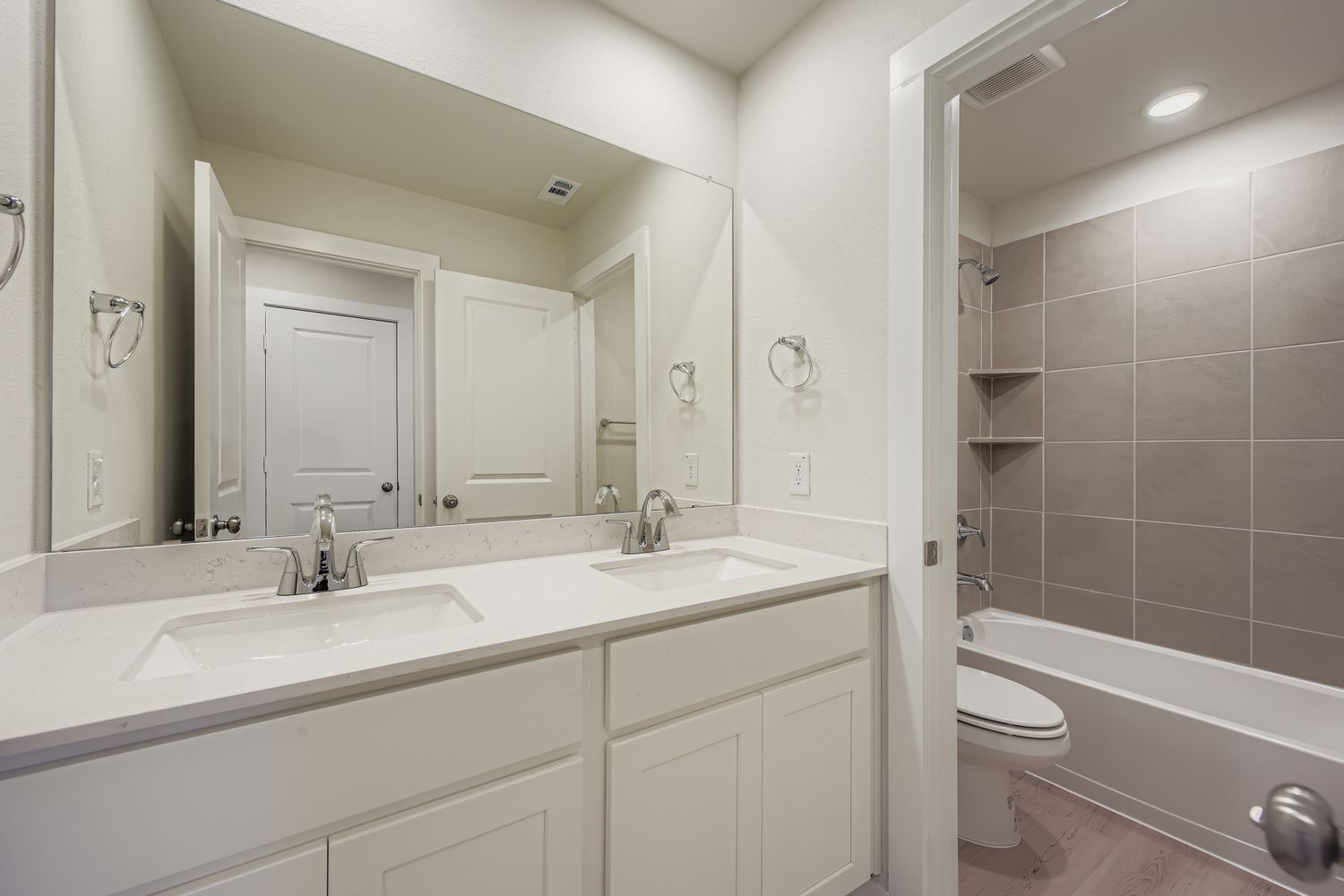 A bathroom with a tub sink and toilet.