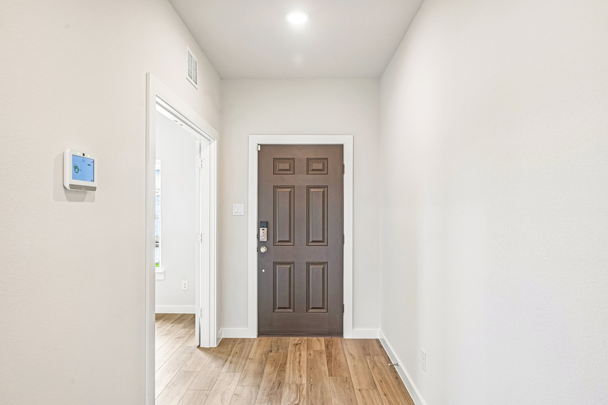 A hallway with white walls.