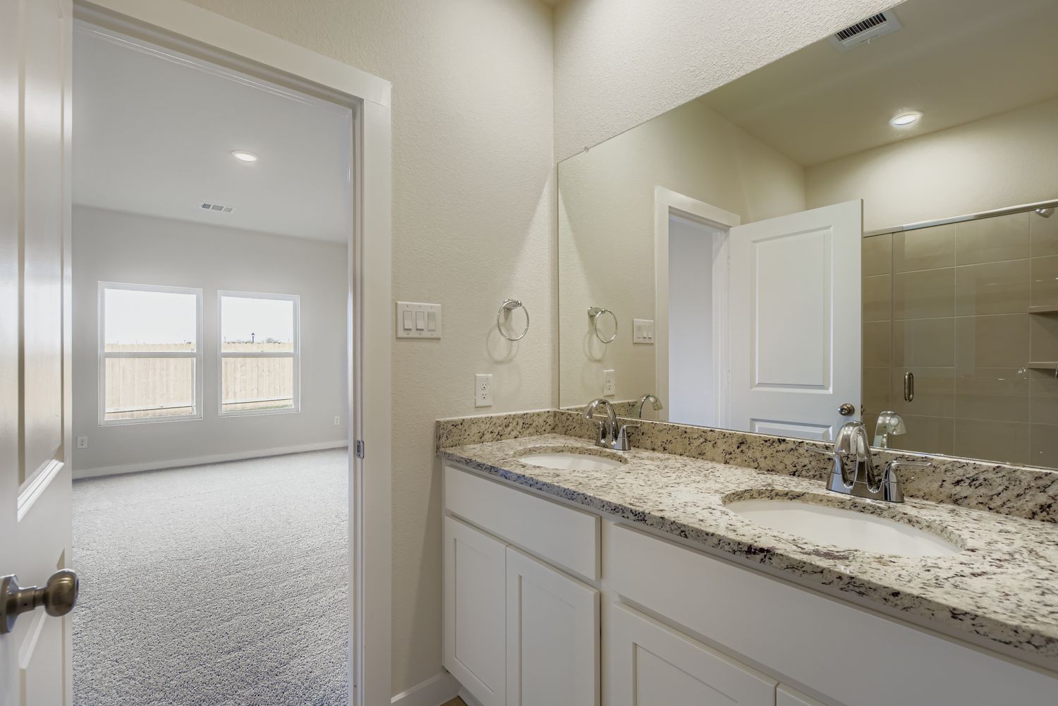 A bathroom with a marble countertop.