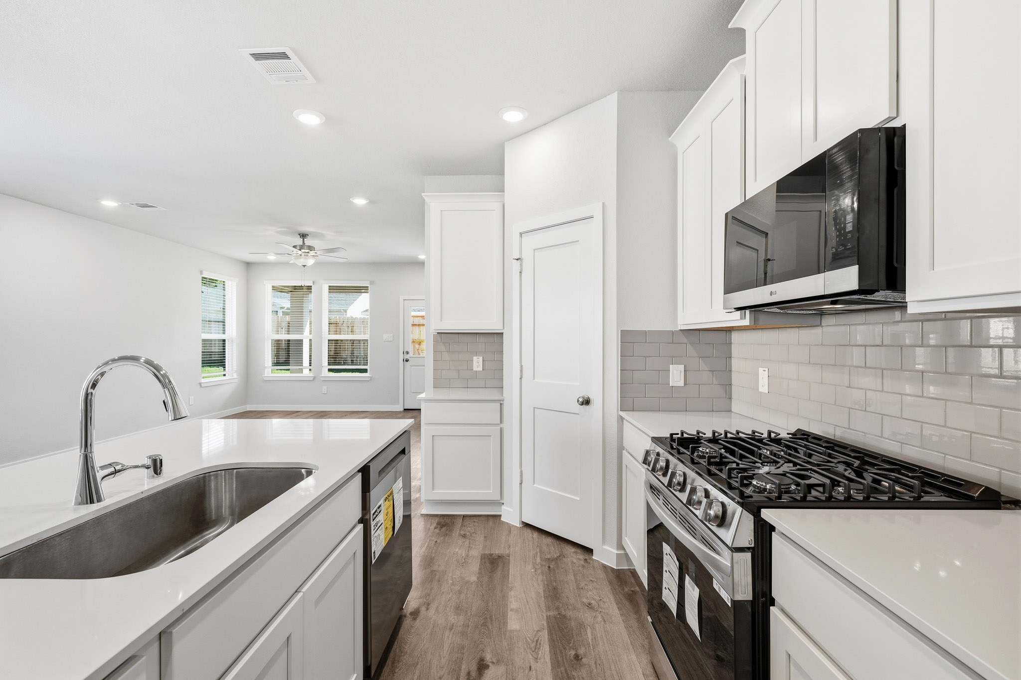 A kitchen with white cabinets.