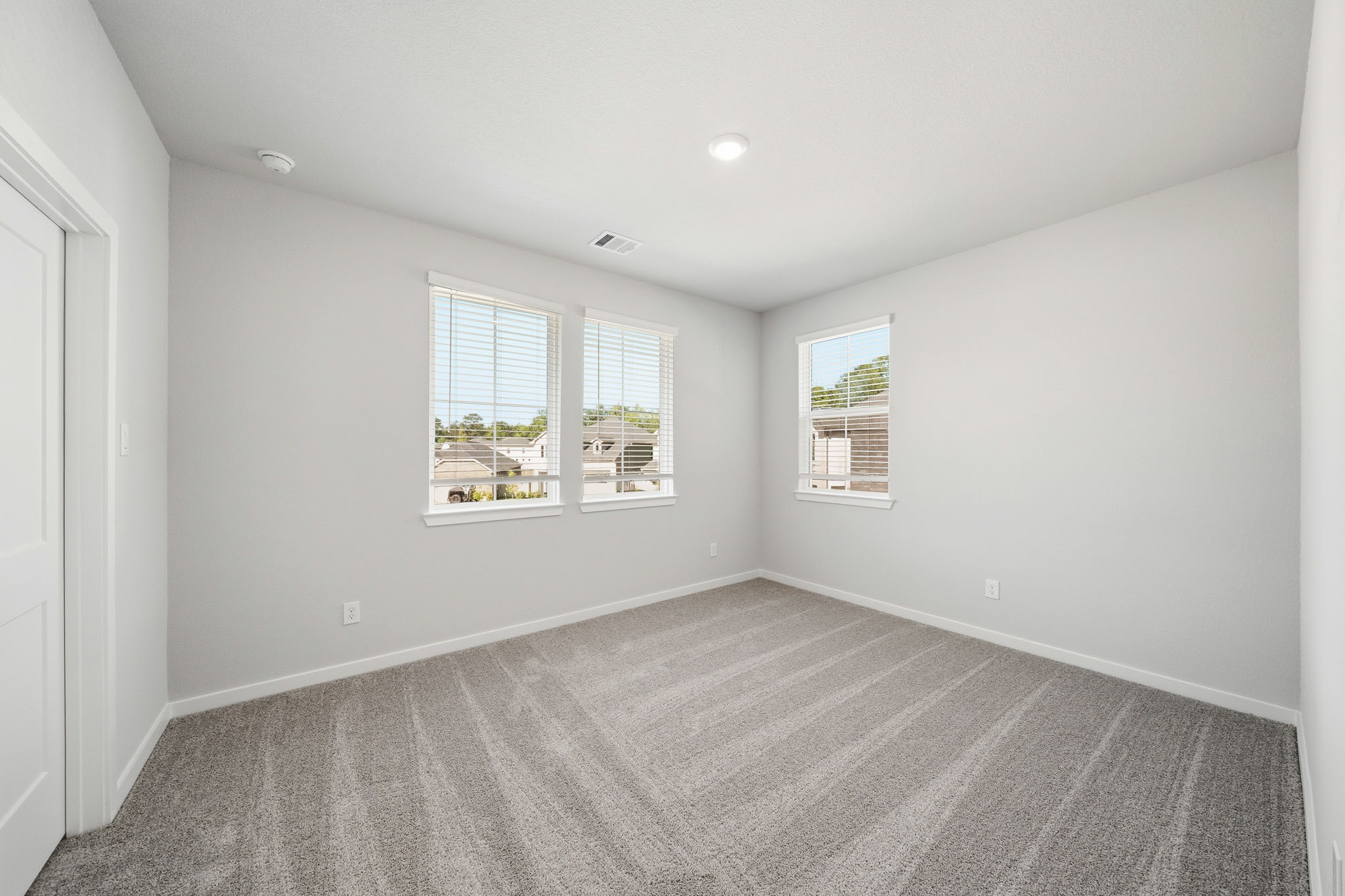 A room with a window and a carpet.