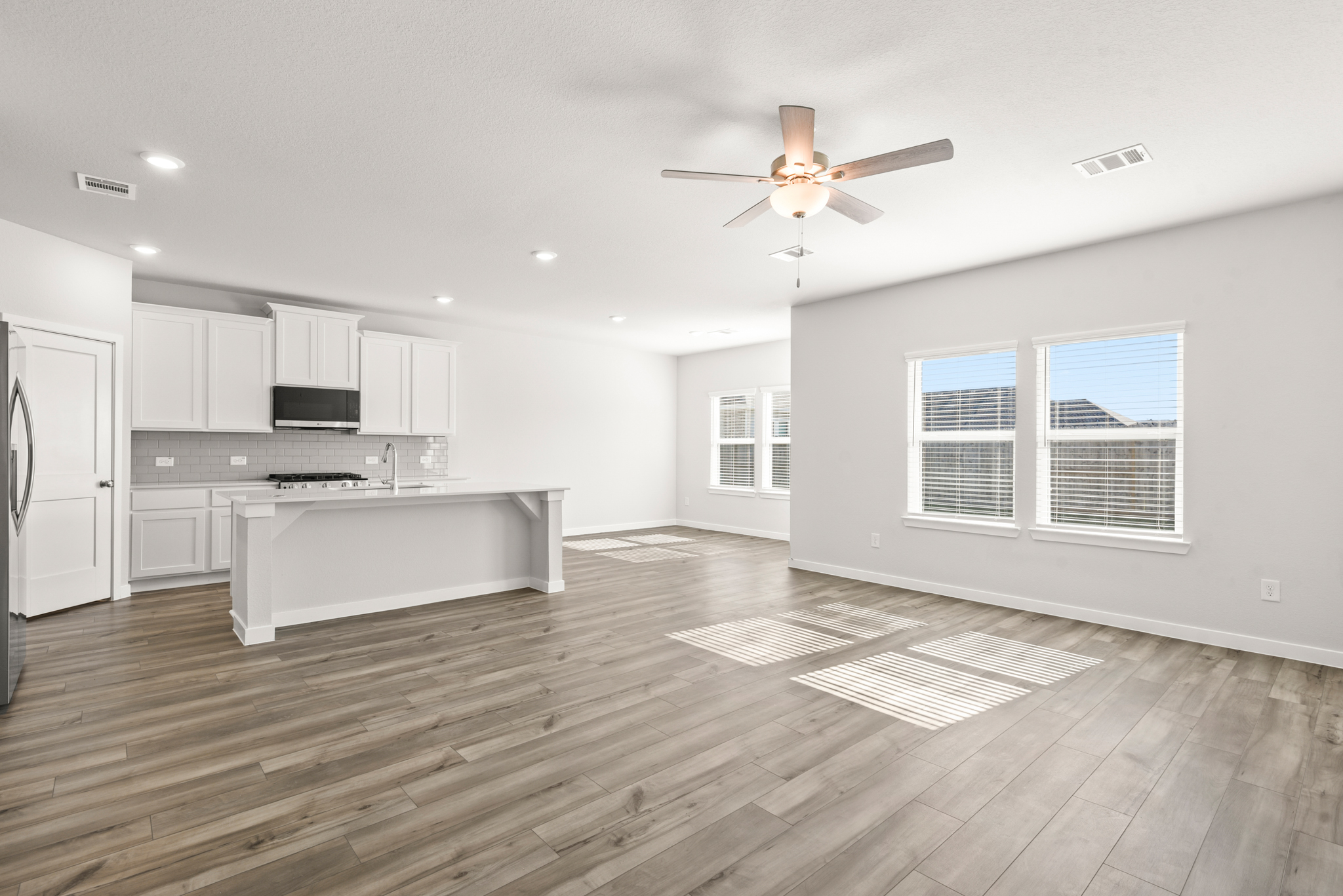 A kitchen with white cabinets.