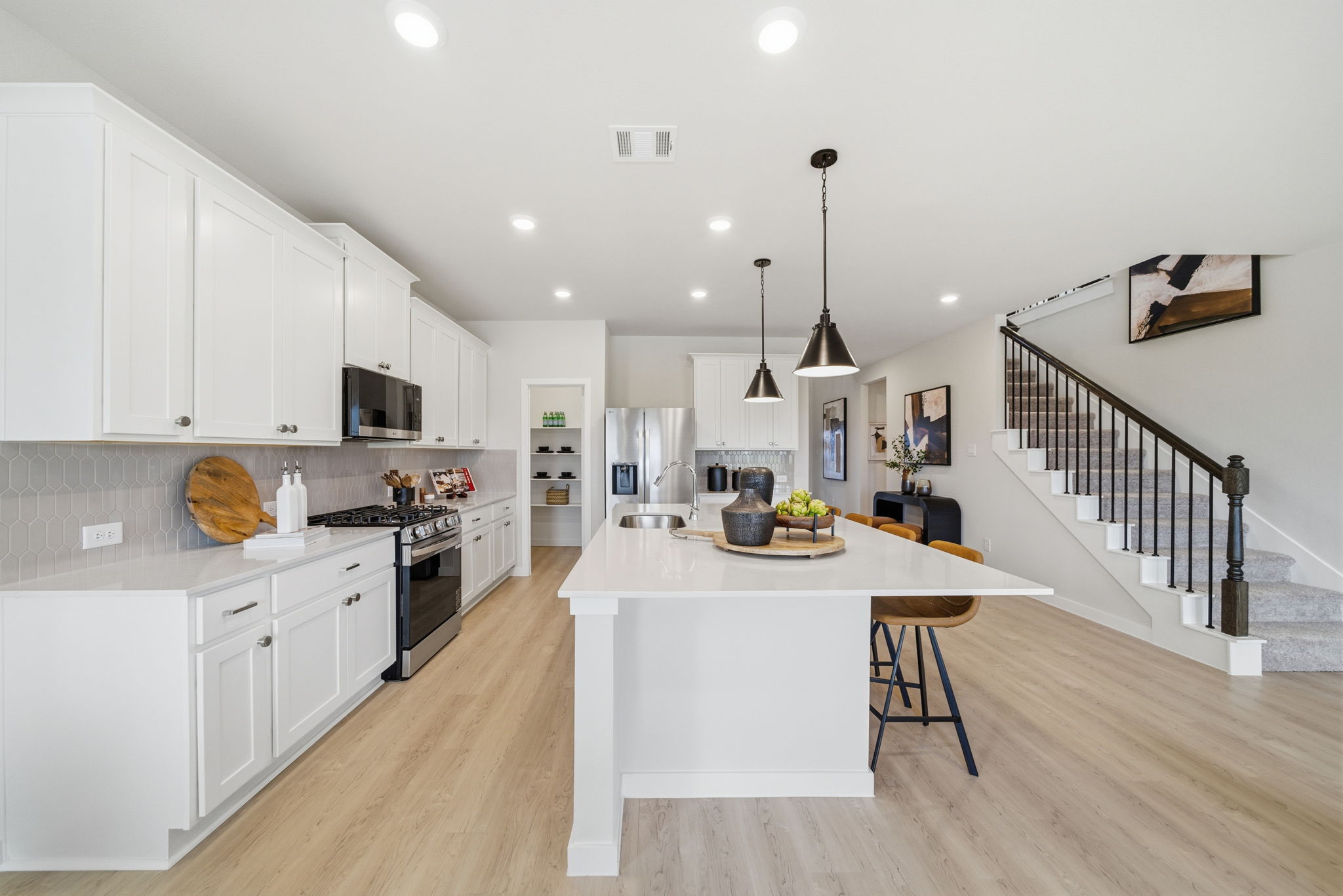 A kitchen with white cabinets.