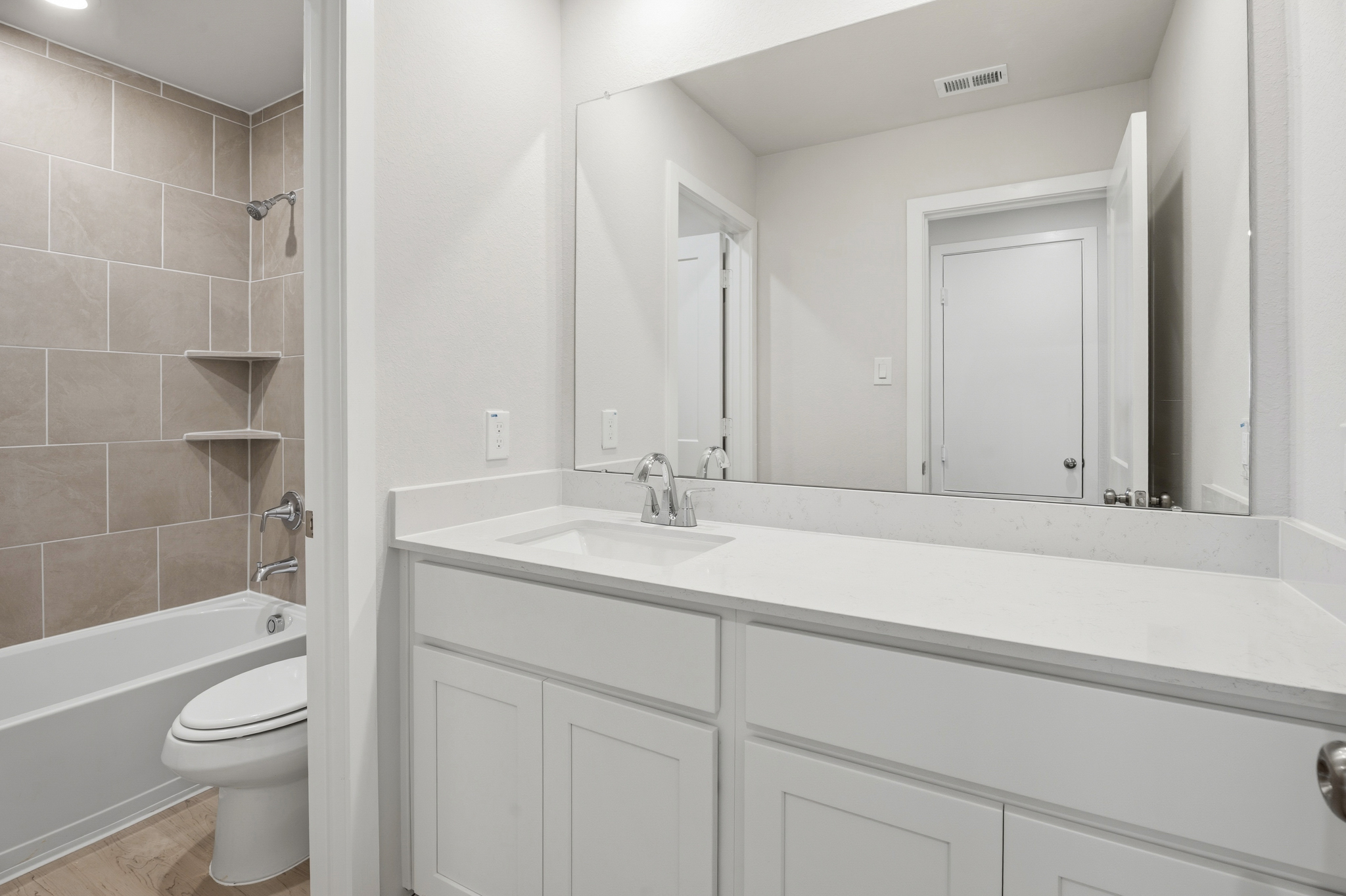 A bathroom with a tub sink and toilet.
