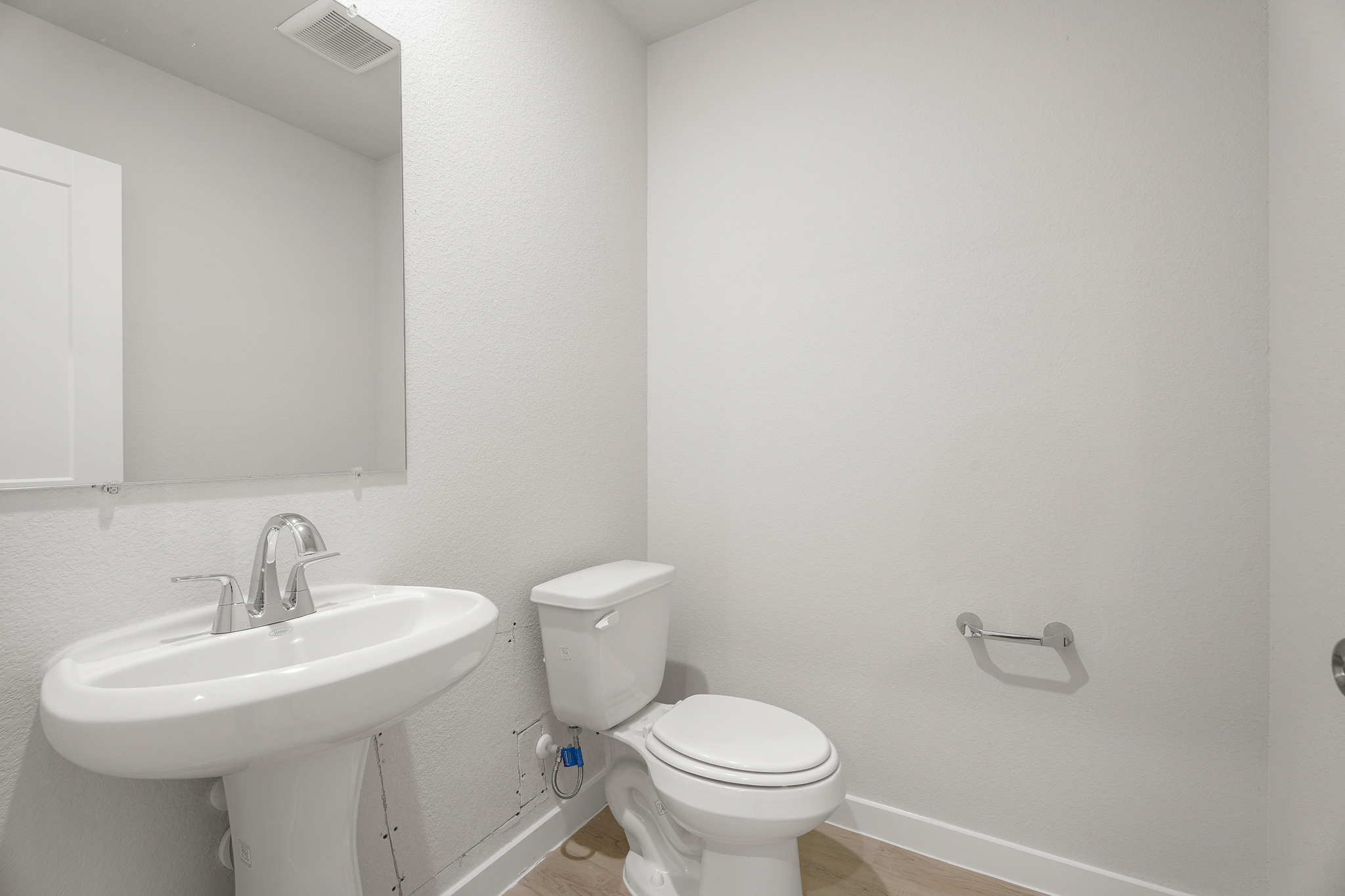 A bathroom with a toilet and sink.