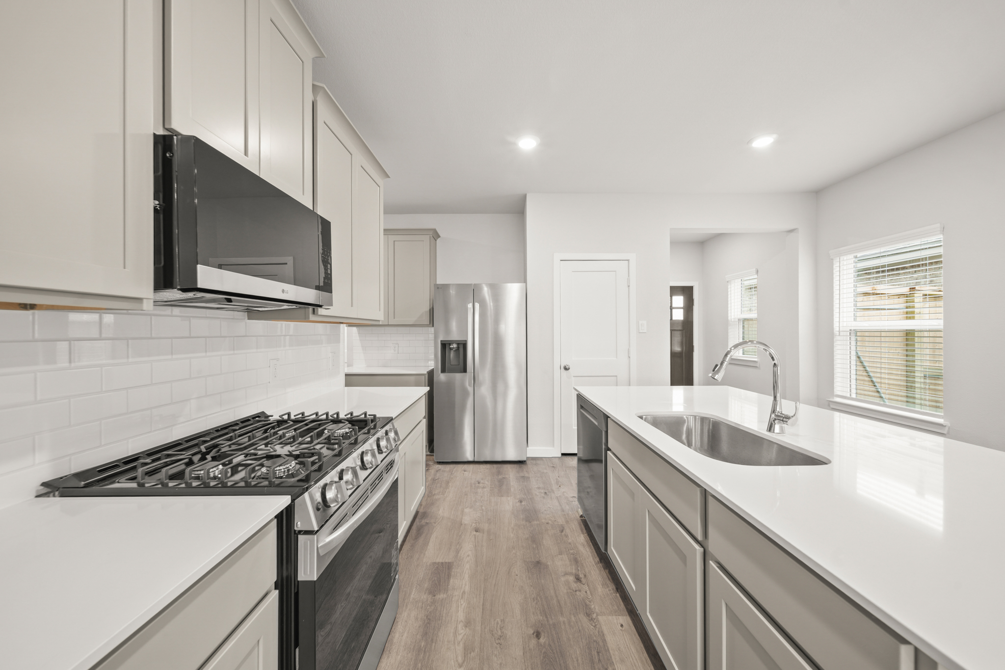 A kitchen with white cabinets.