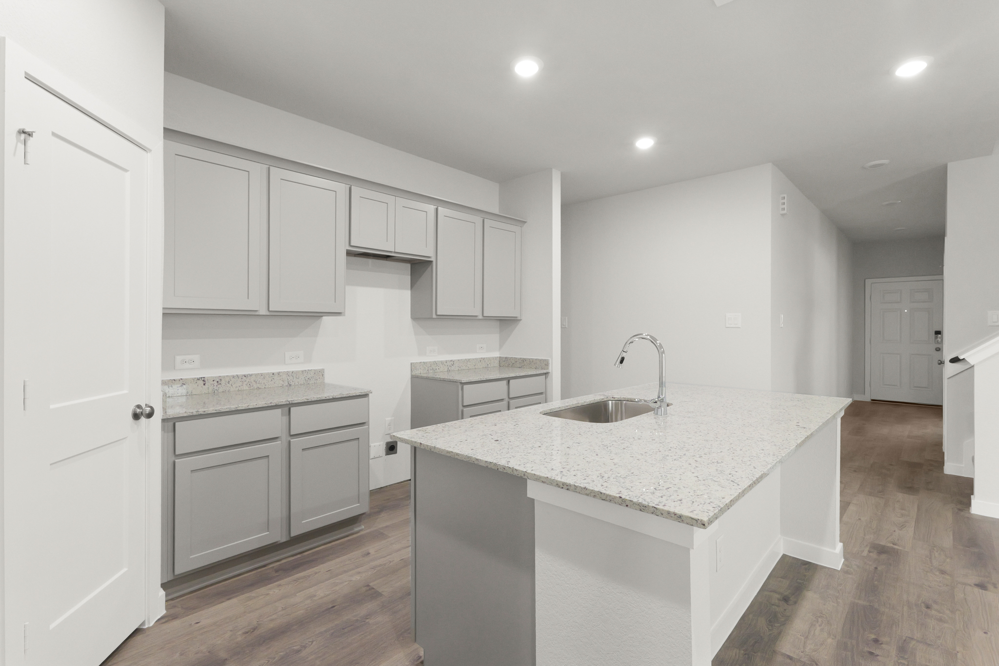 A kitchen with white cabinets.