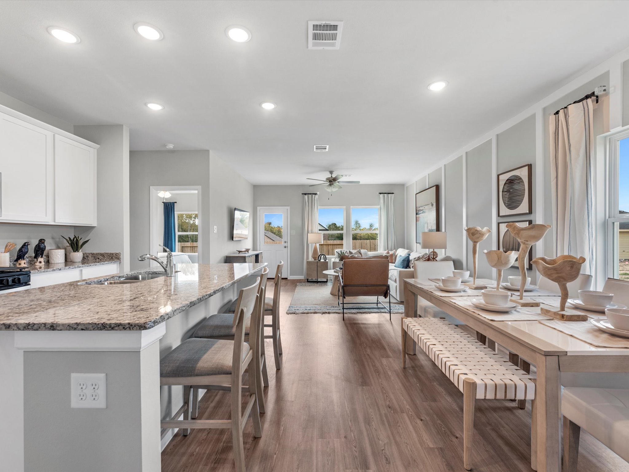 A kitchen with a dining table and chairs.