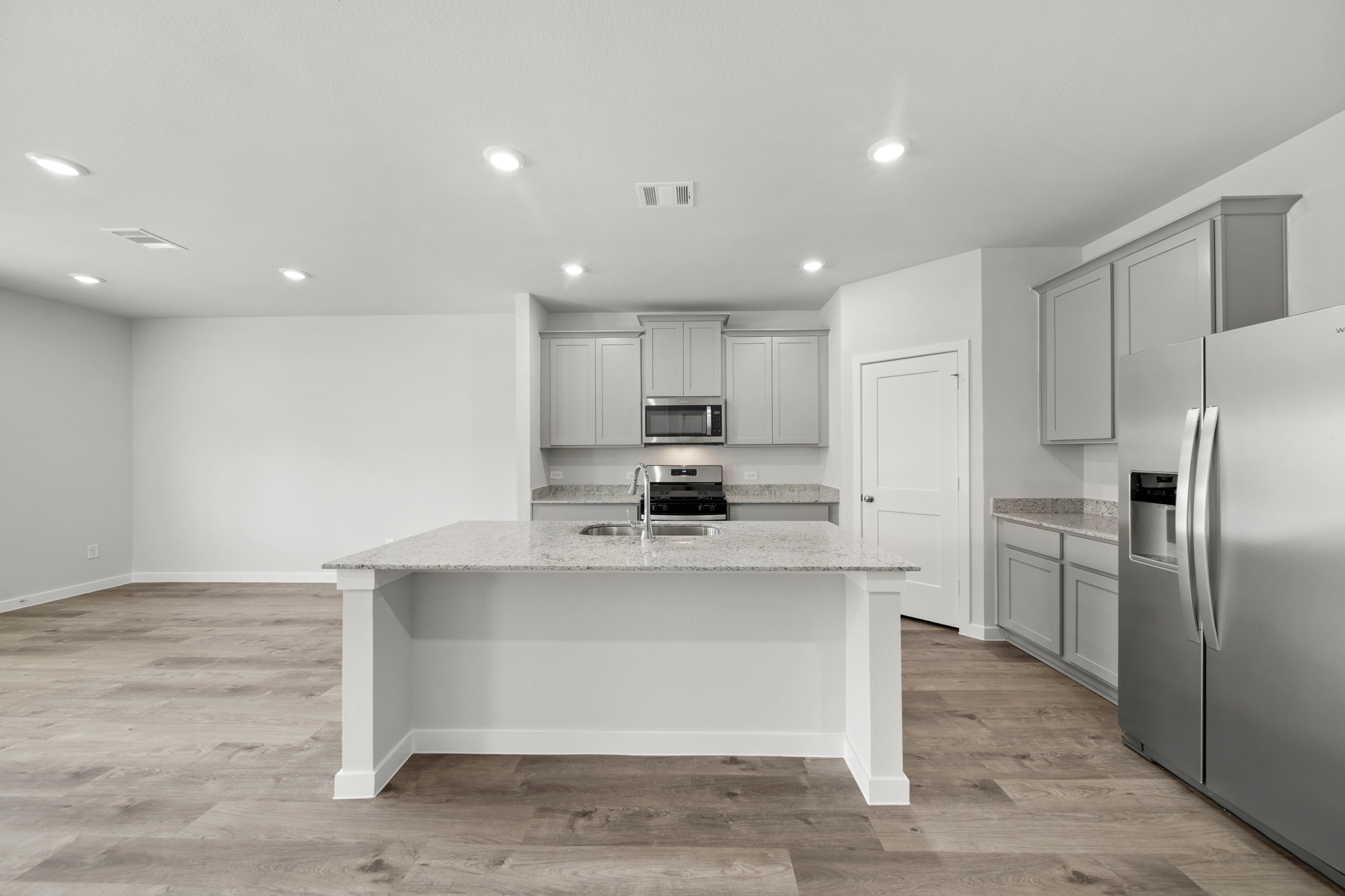 A kitchen with white cabinets.