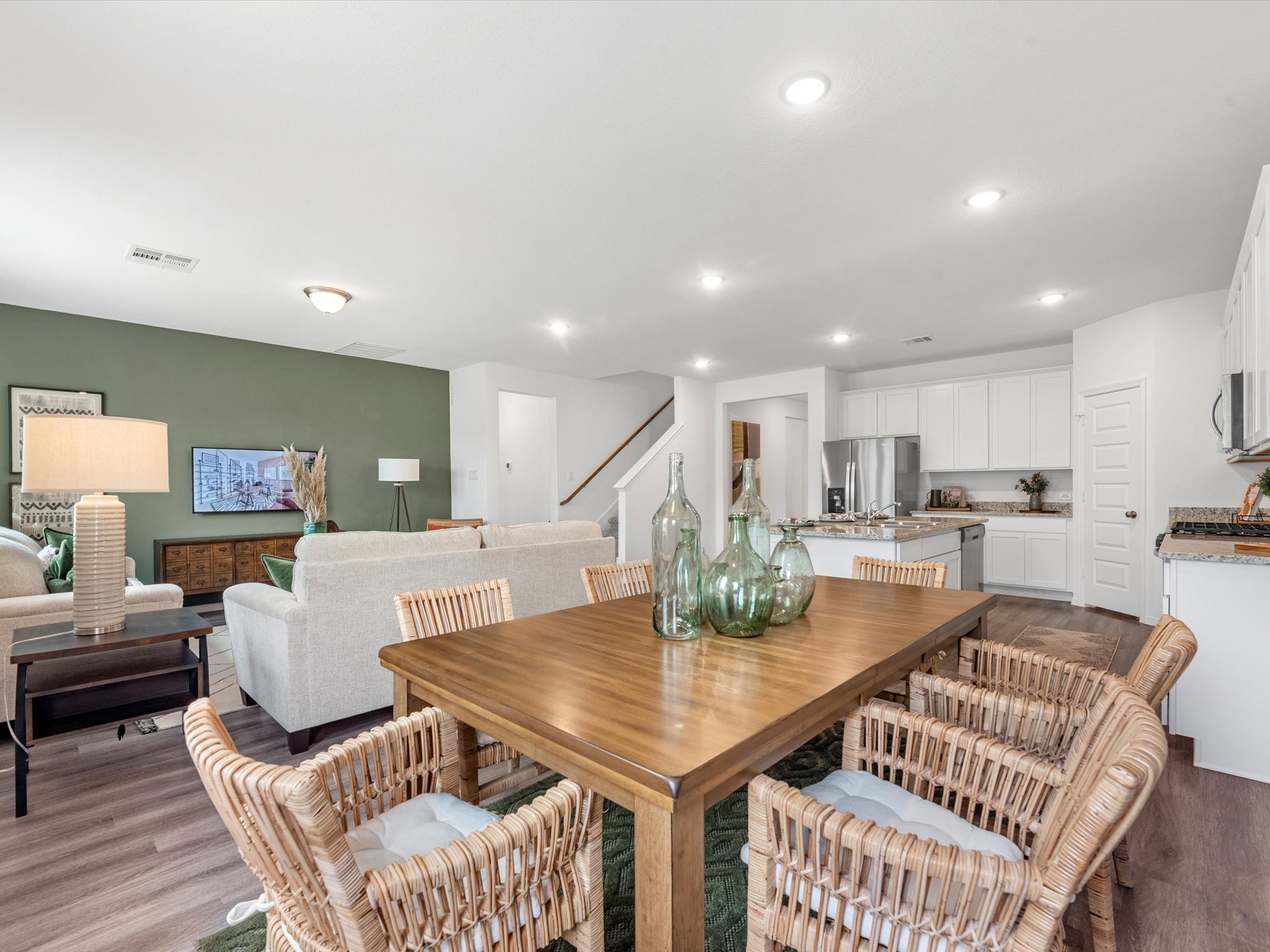 A large kitchen with a dining table.