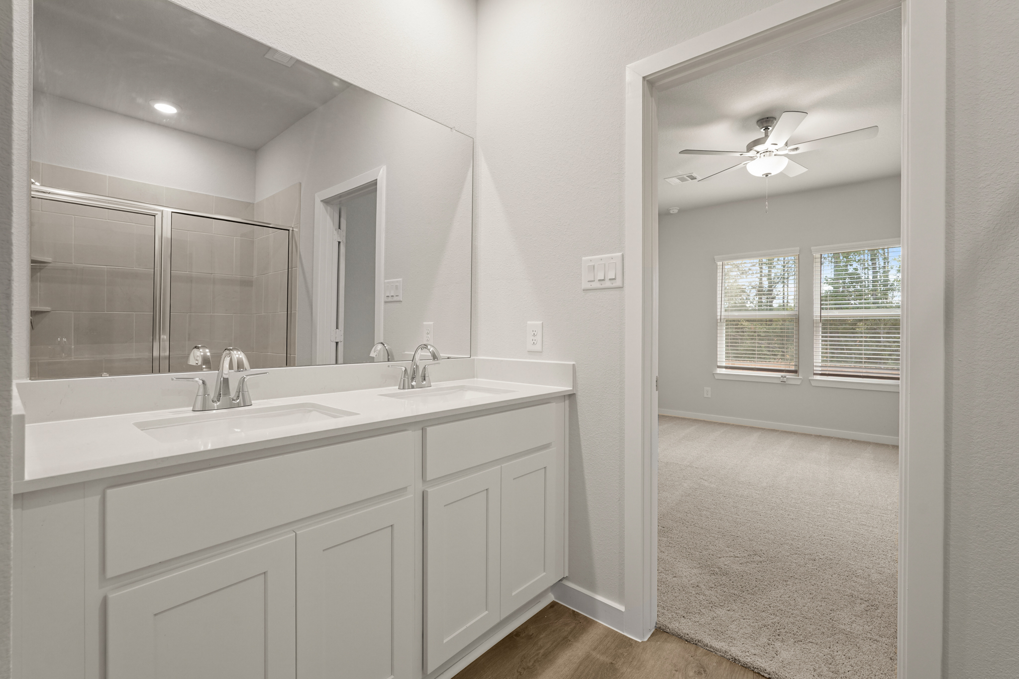 A bathroom with a large mirror.
