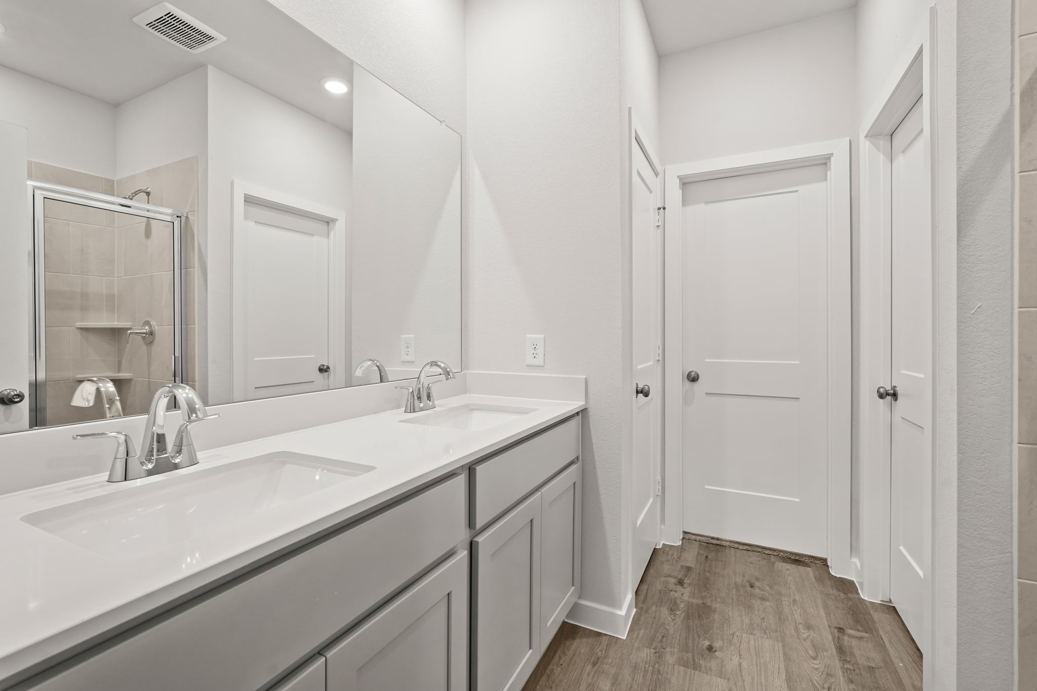 A bathroom with a large mirror.