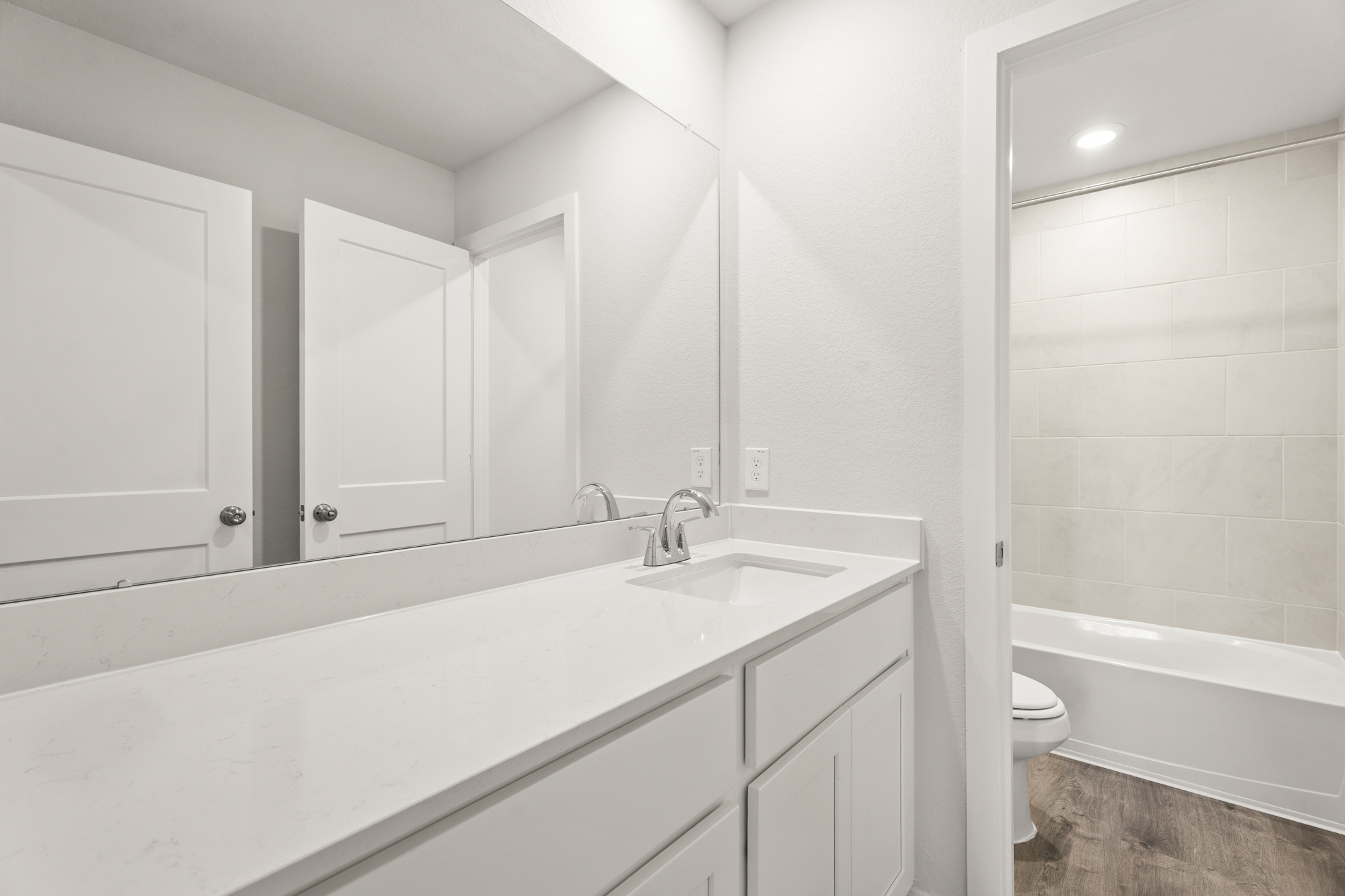 A bathroom with a tub sink and toilet.