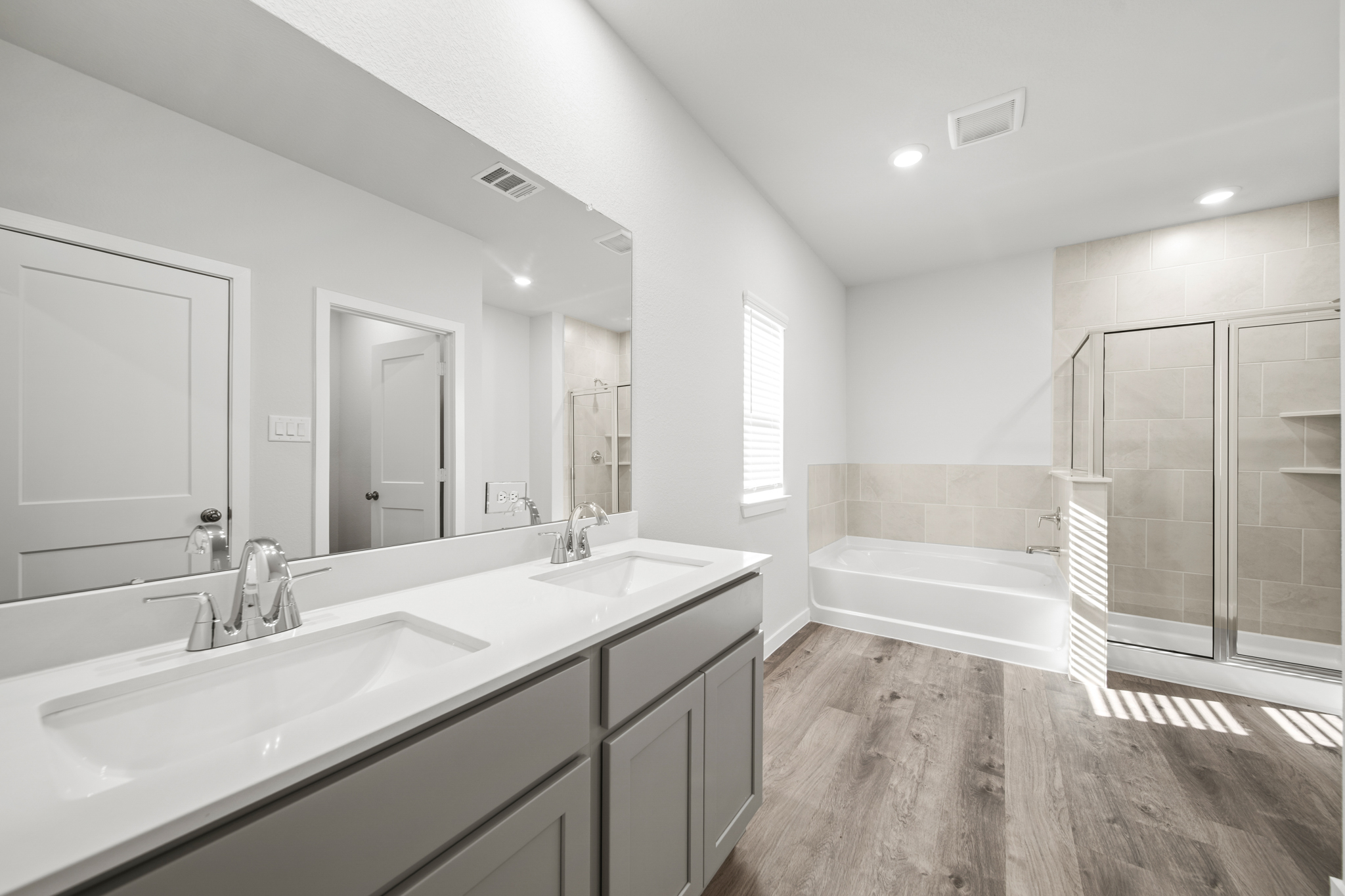 A bathroom with a tub sink and a shower.