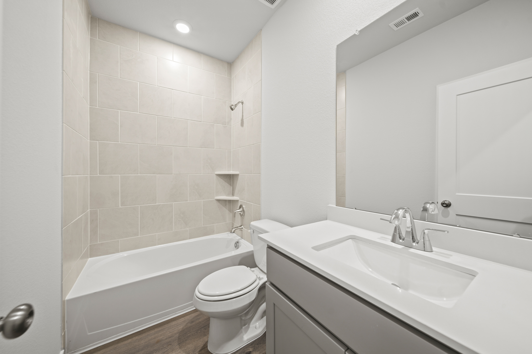 A bathroom with a tub sink and toilet.