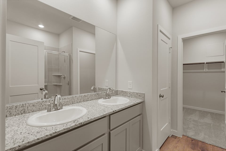 A bathroom with a large mirror.