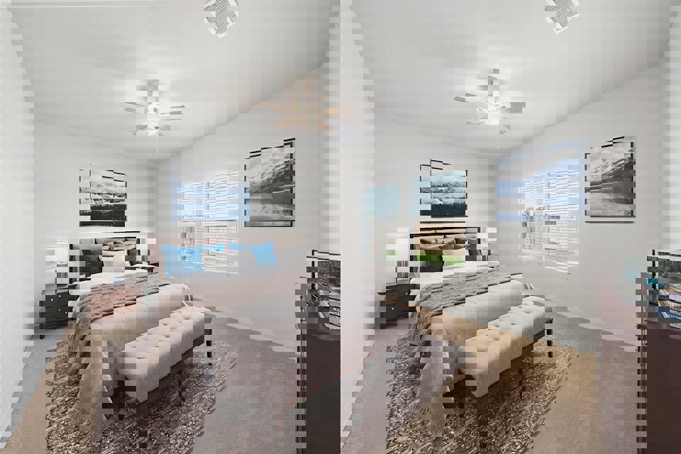 A bedroom with a bed and a bench.