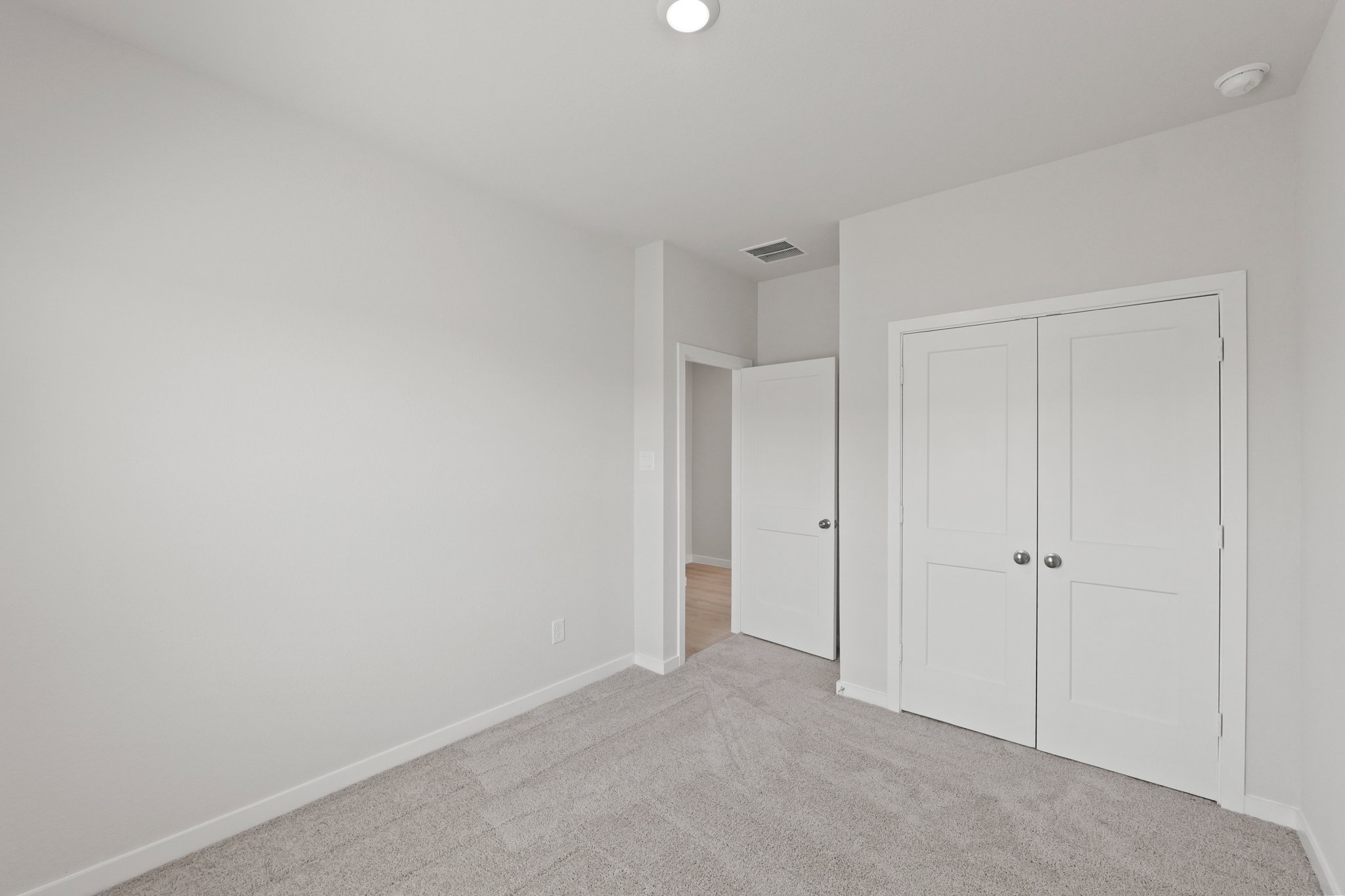 A hallway with white doors.