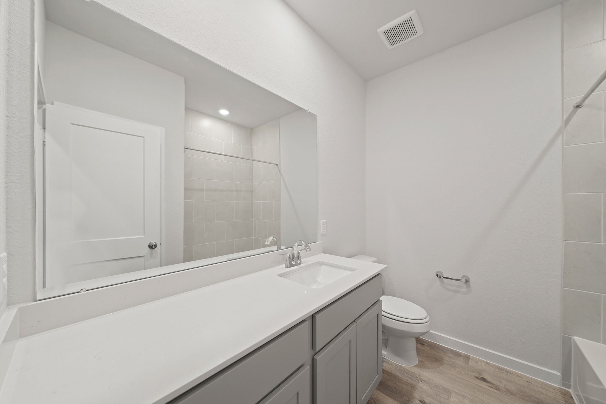 A bathroom with a tub sink and toilet.