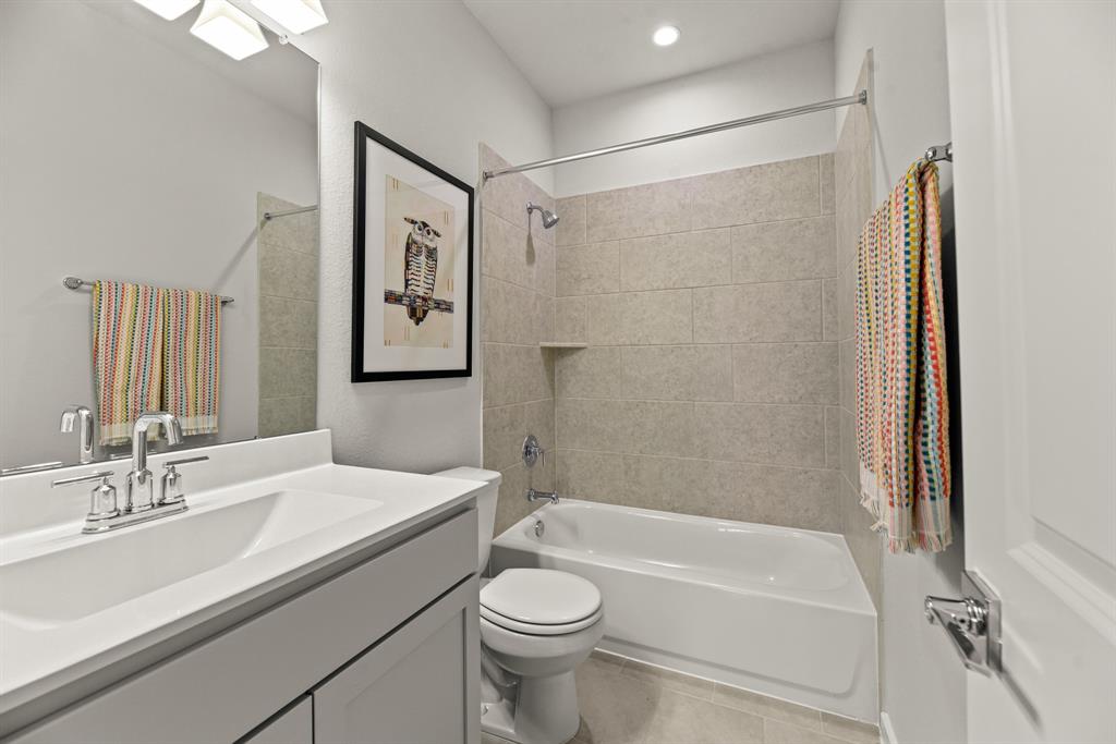 A bathroom with a tub sink and toilet.