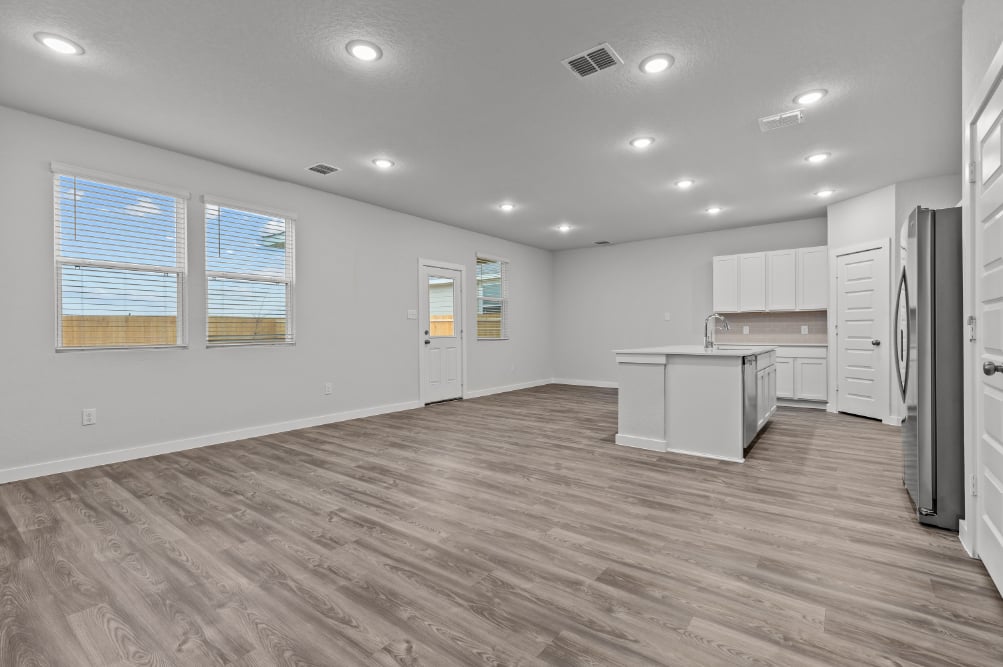 A kitchen with white cabinets.