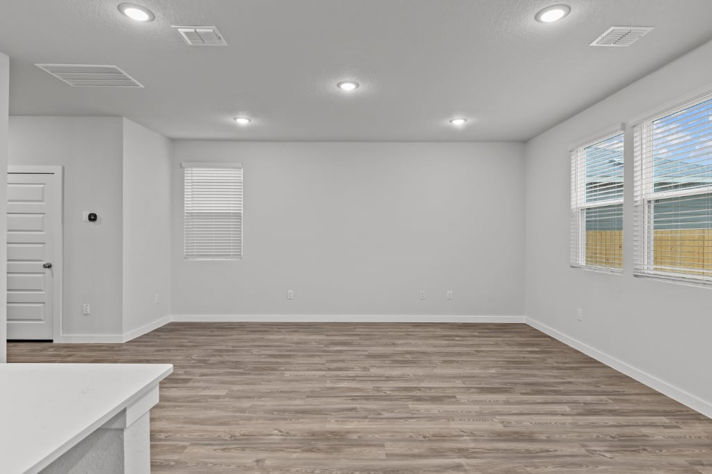 A room with a wood floor and white walls.