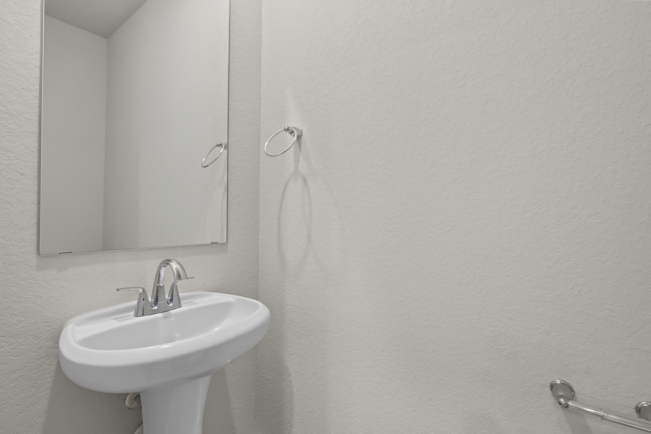 A bathroom with a sink and mirror.