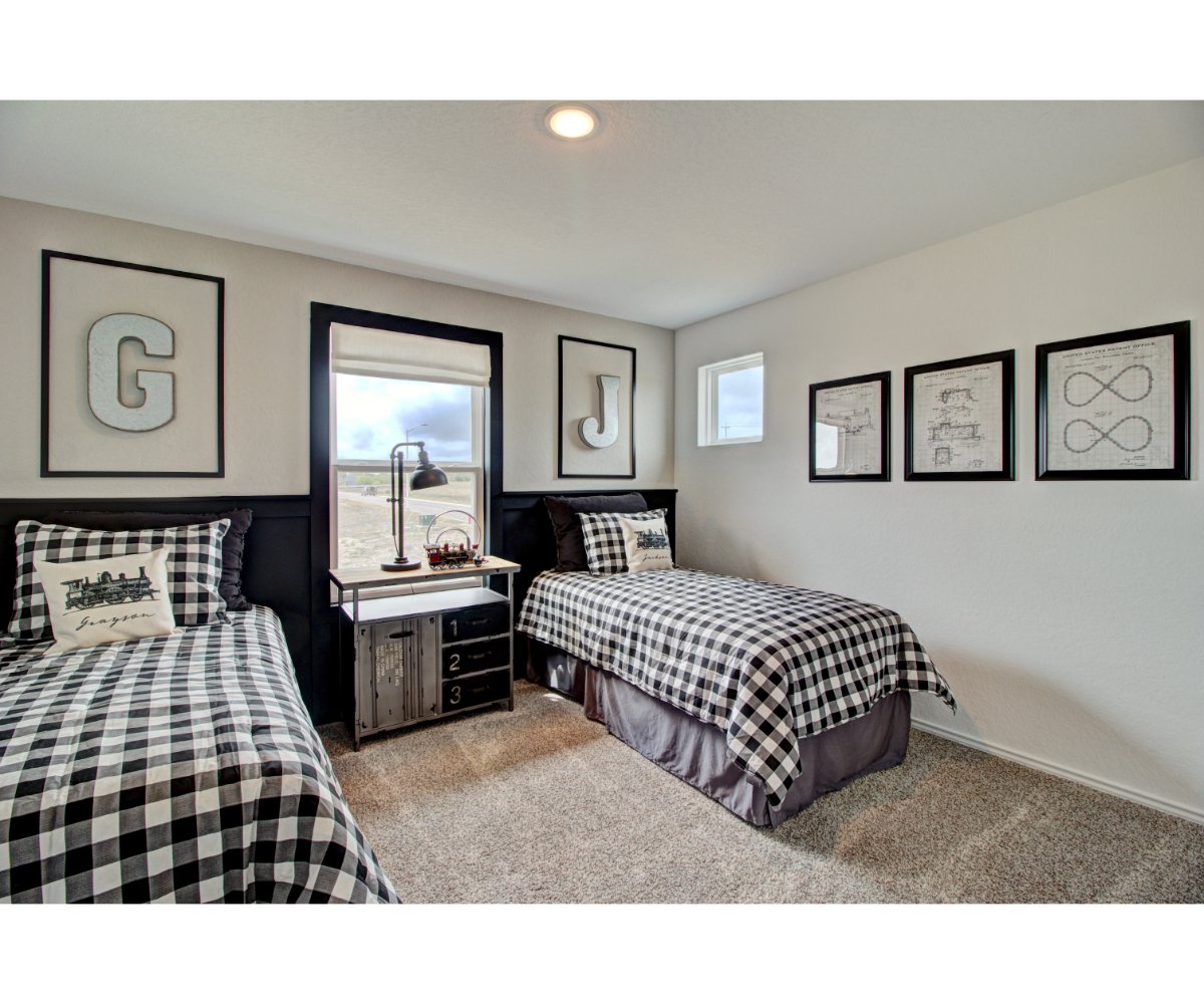 A bedroom with a bed and a mirror.