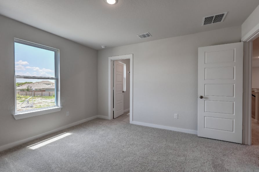 A room with white walls and a window.