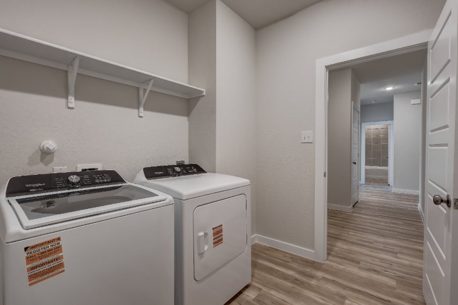 A kitchen with a washer and dryer.