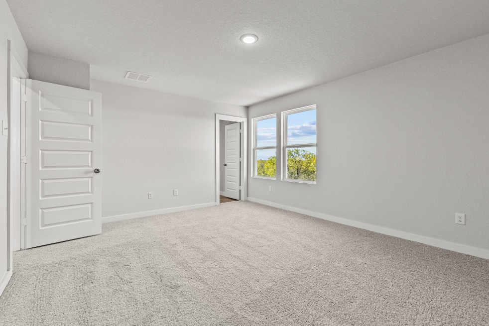 A room with white walls and a window.