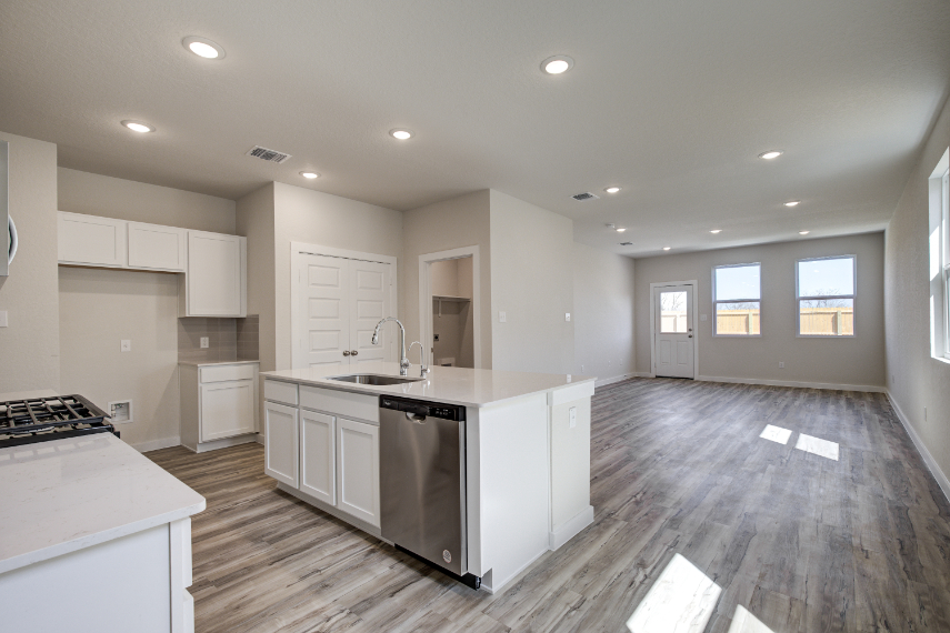 A kitchen with white cabinets.