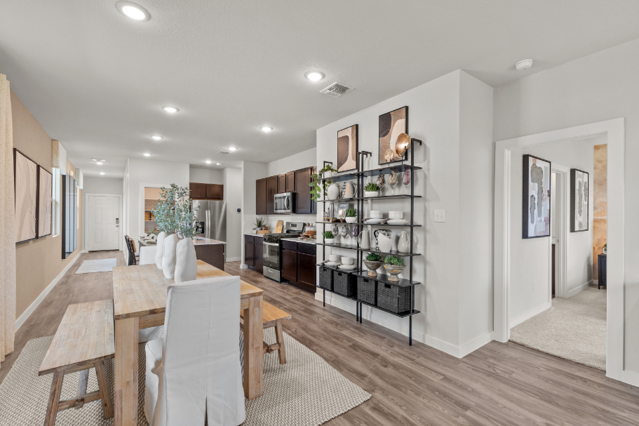 A dining room with a table and chairs.