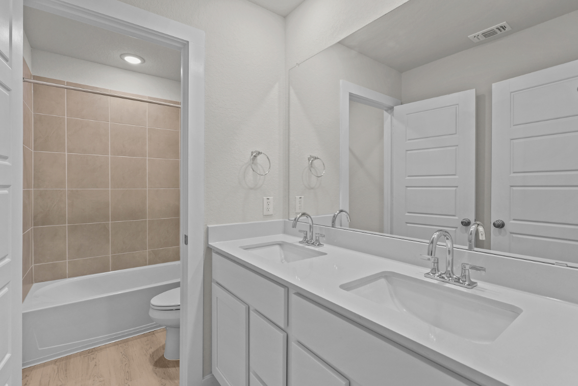 A bathroom with a tub sink and toilet.