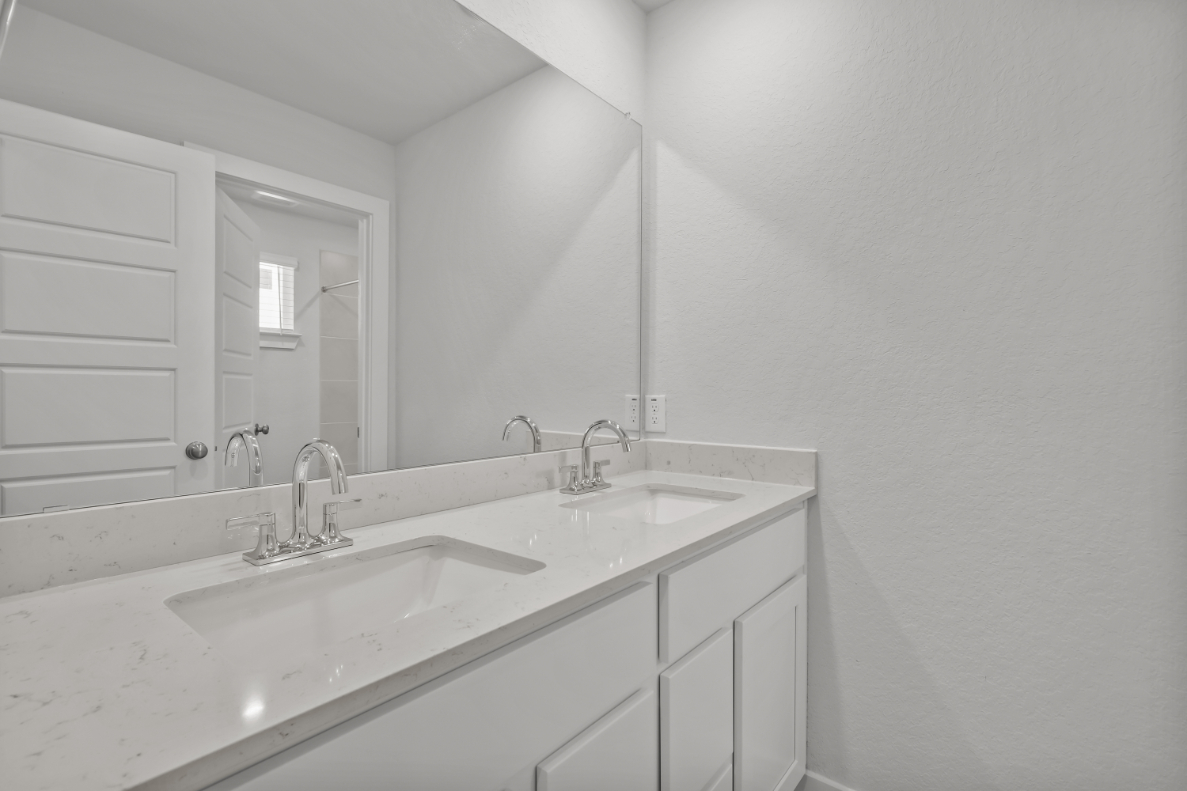 A bathroom with a large mirror.