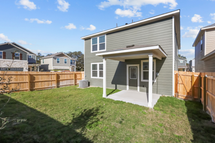 A house with a fence and grass.