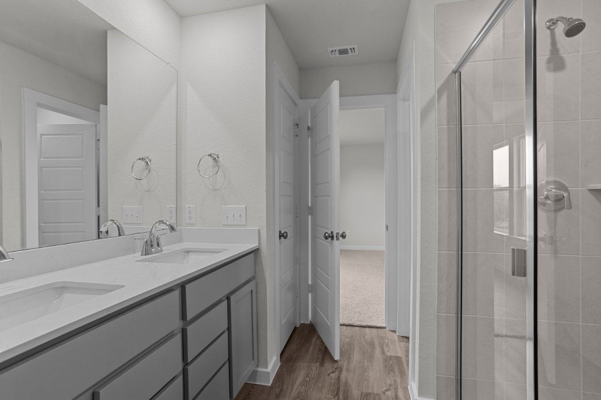 A bathroom with a shower and sink.