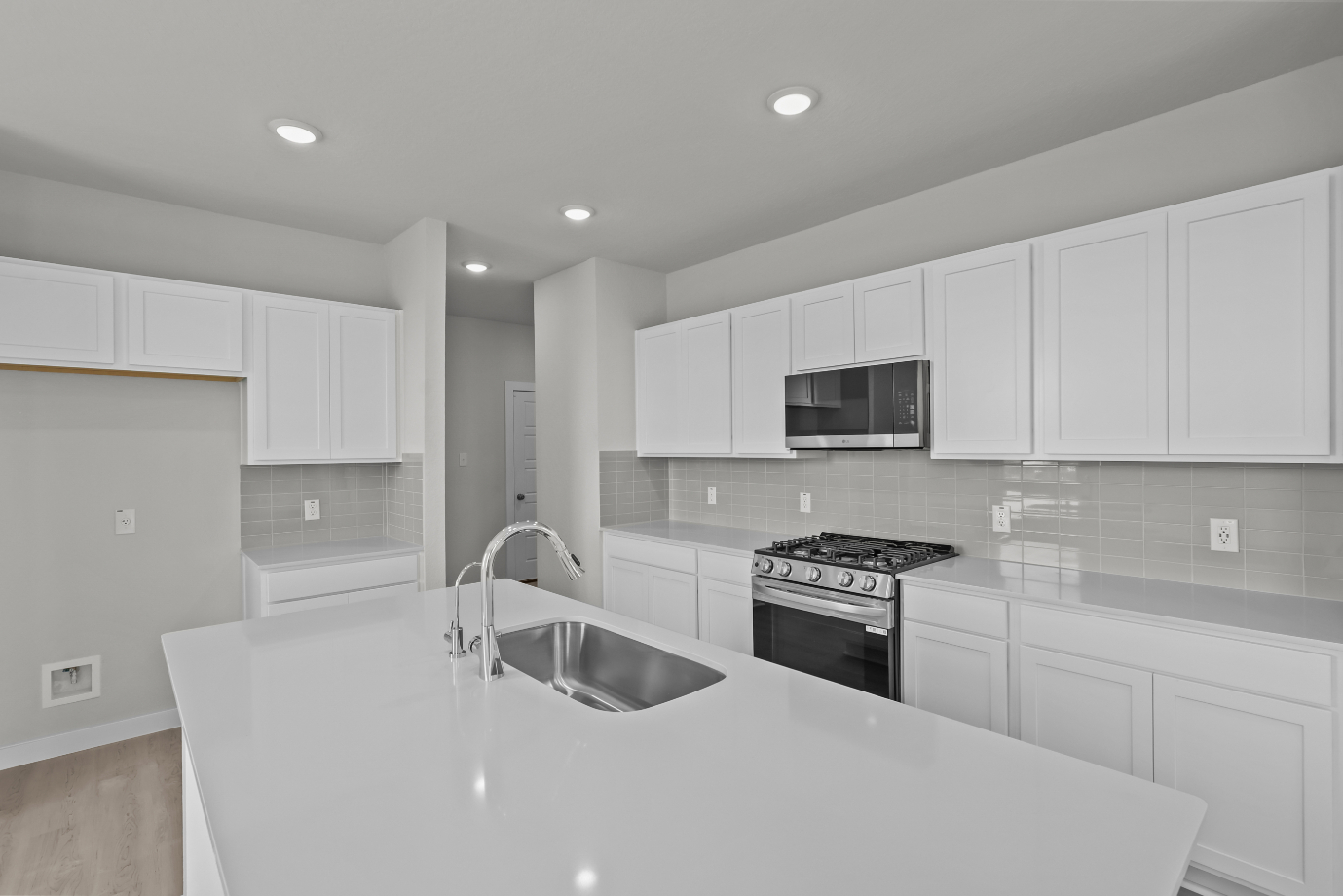 A kitchen with white cabinets.
