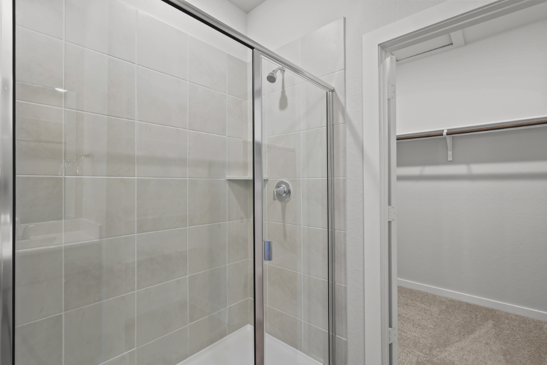 A shower with a glass door.