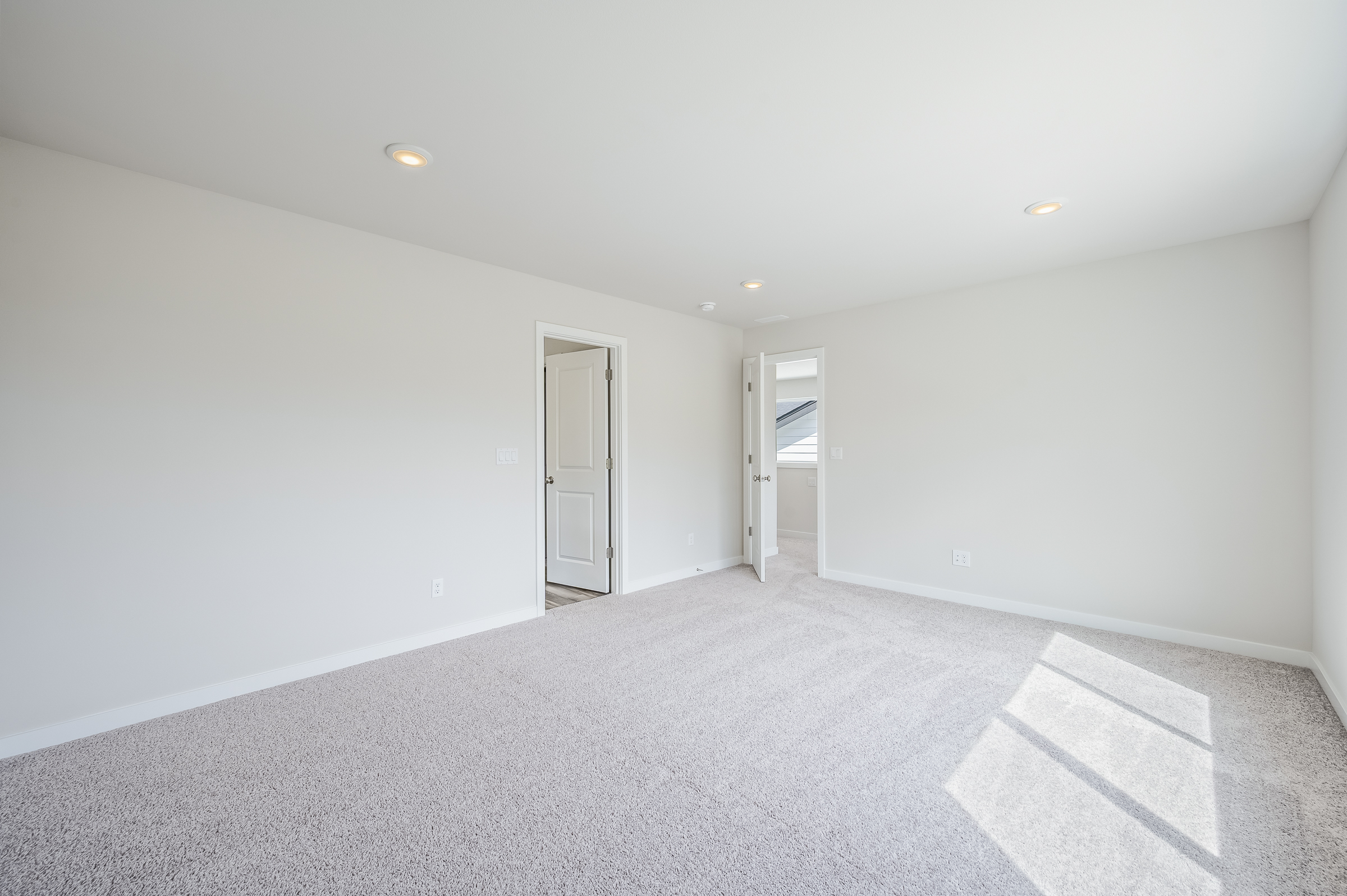 A hallway with white walls.