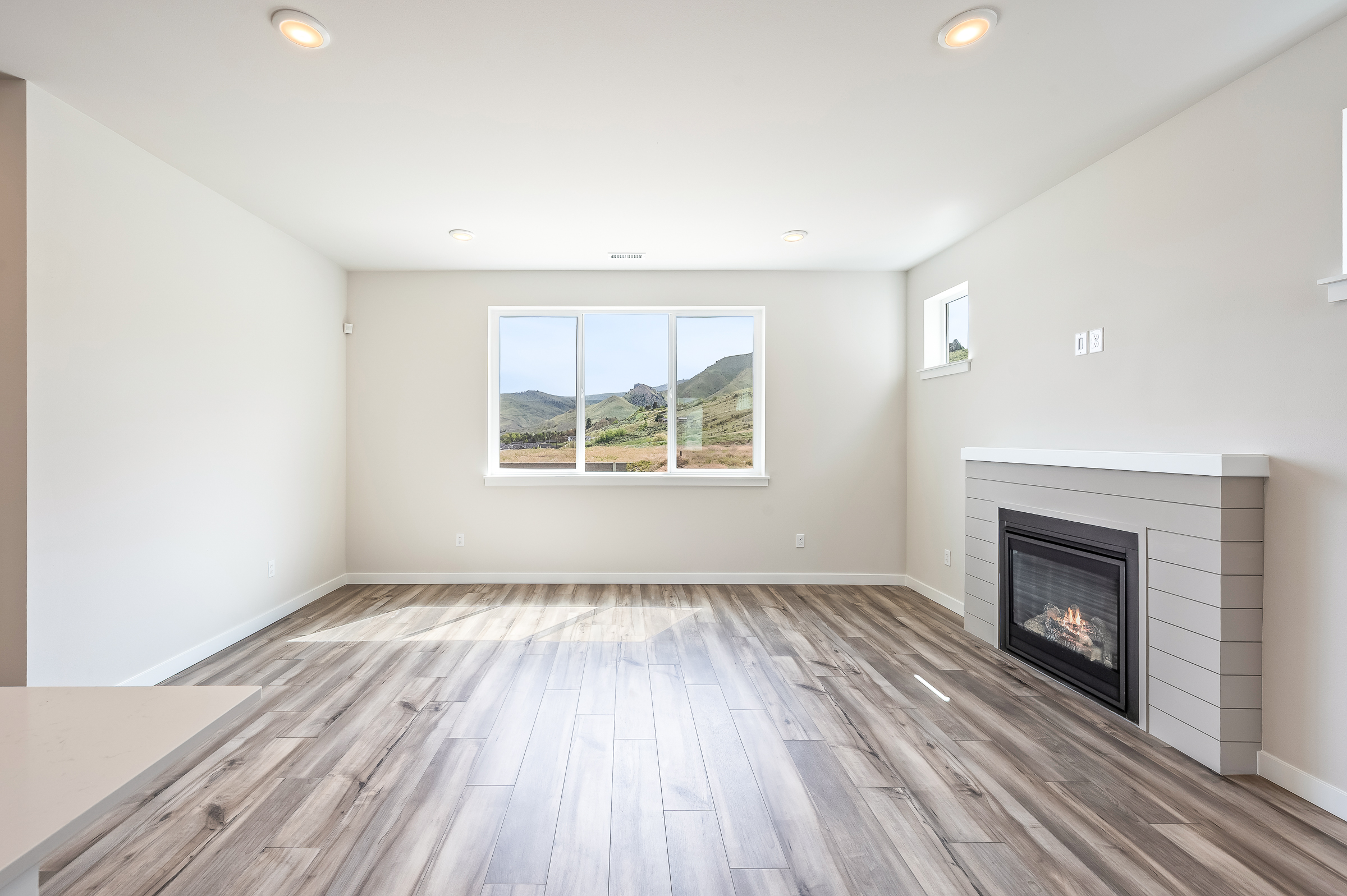 A room with a fireplace and a wood floor.