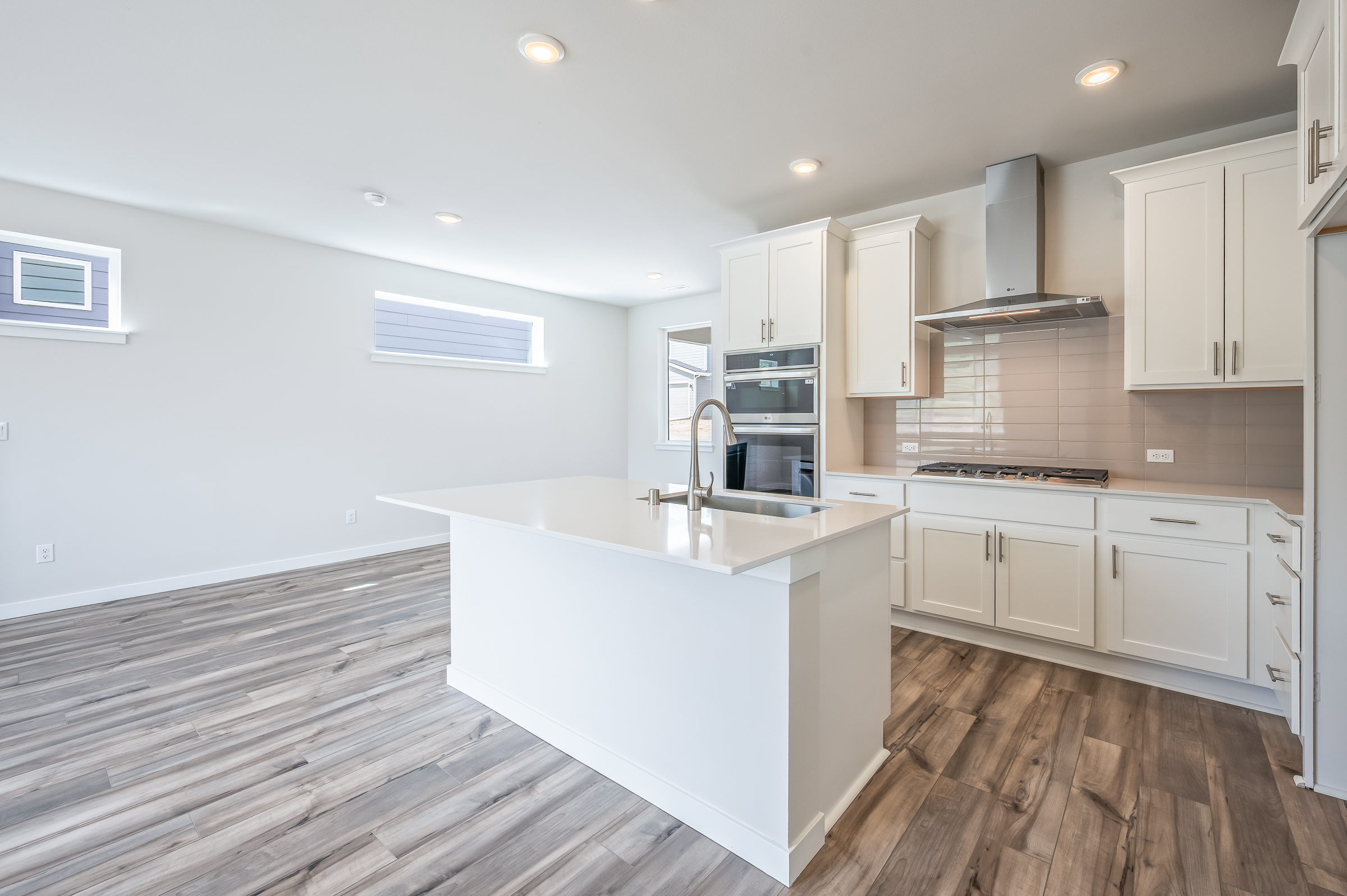 A kitchen with white cabinets.