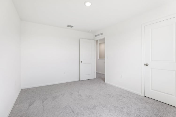A hallway with white doors.